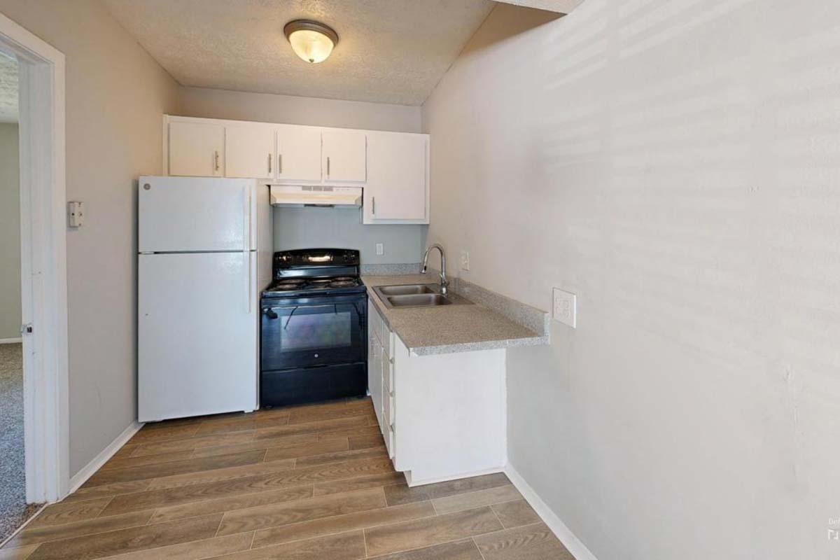 a kitchen with a stove and a refrigerator