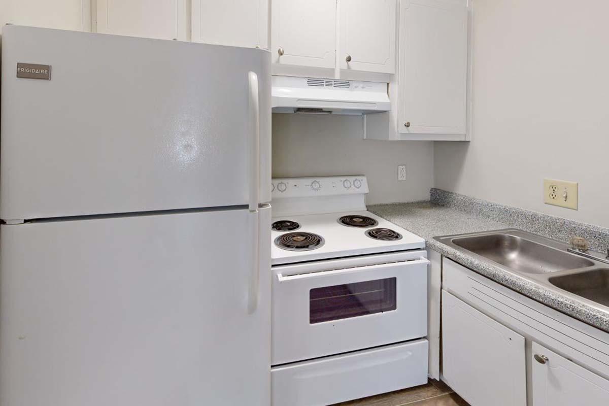 a kitchen with a stove top oven sitting inside of a refrigerator