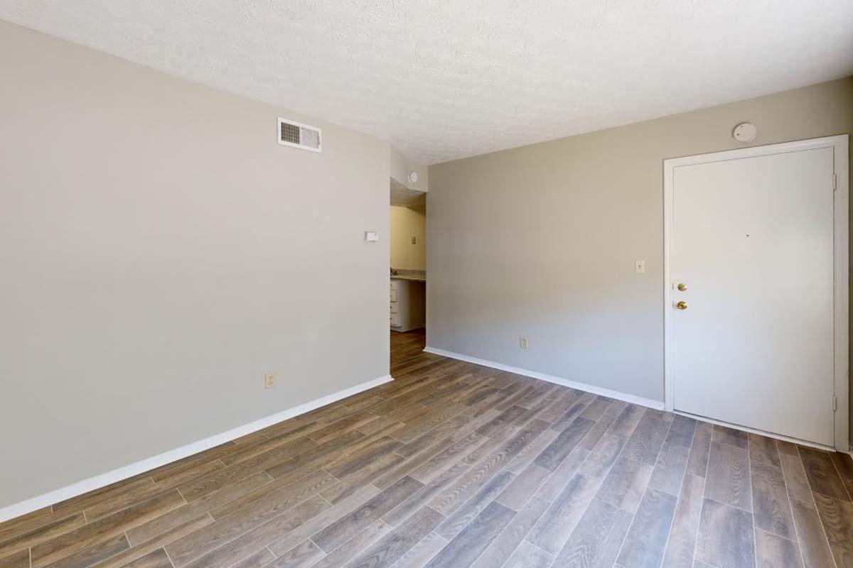 a large empty room with a wood floor