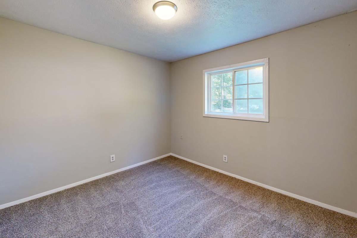 a bedroom with a large window