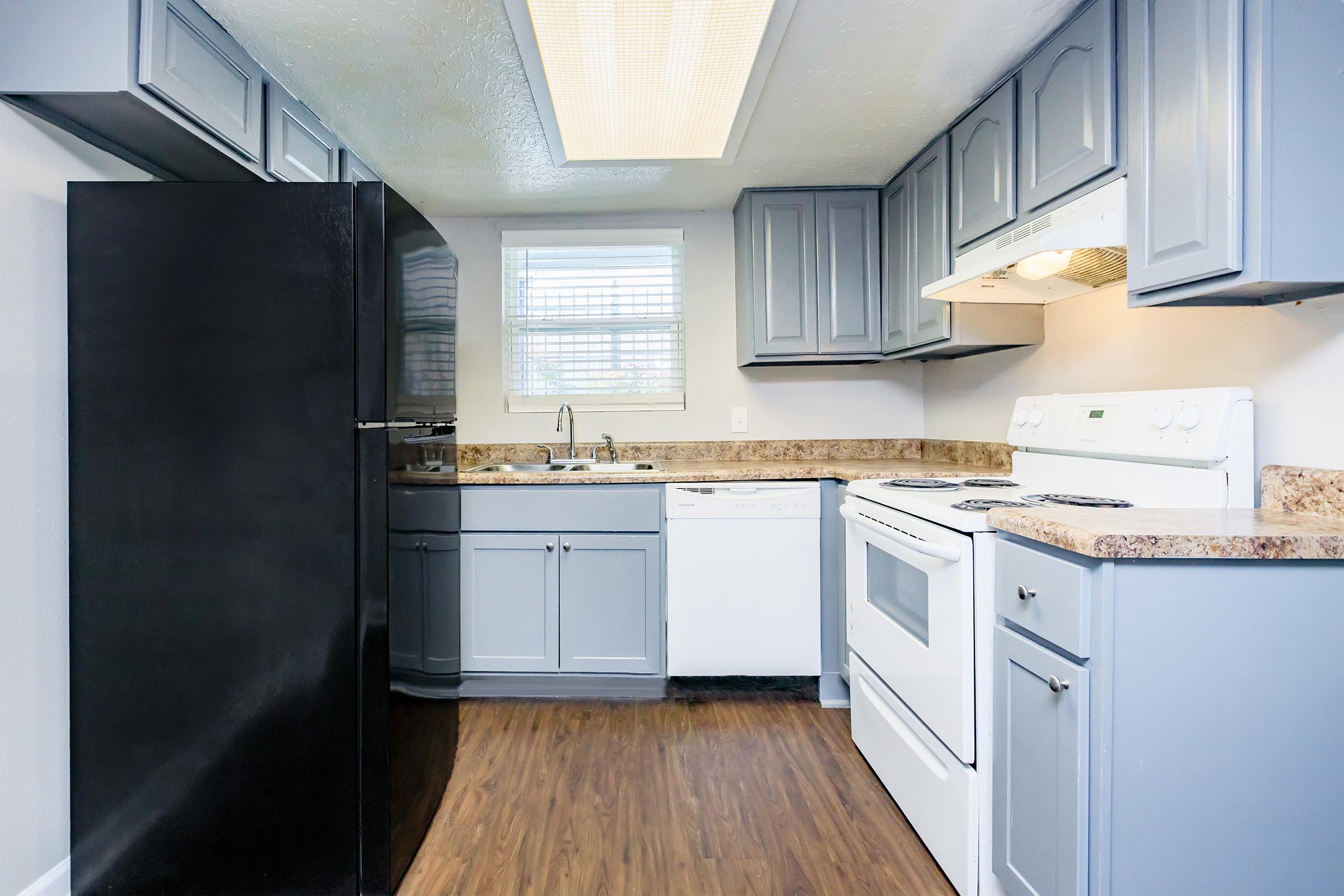 a kitchen with a stove and a refrigerator