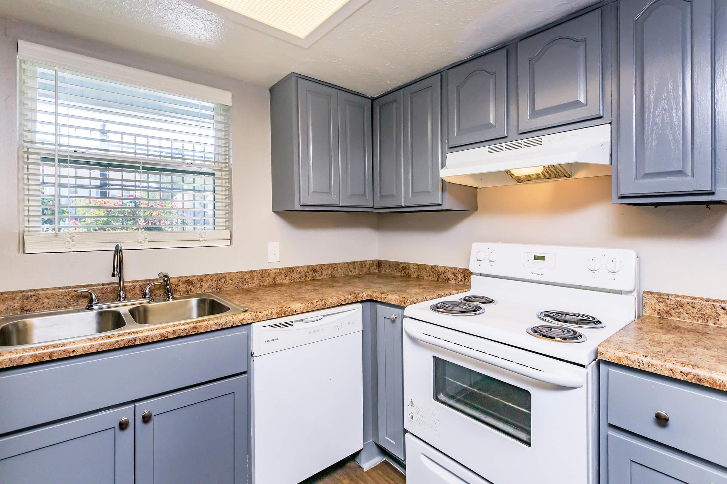 a kitchen with a stove a sink and a microwave