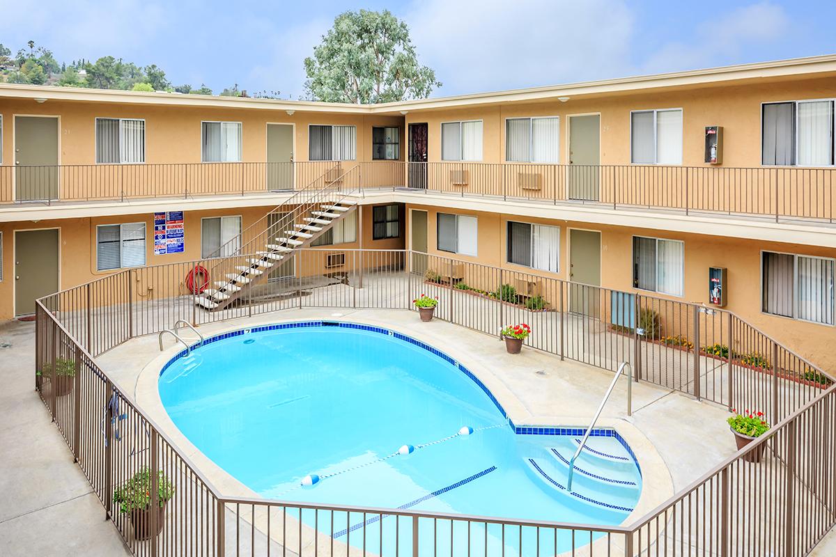 a house with a pool in front of a building