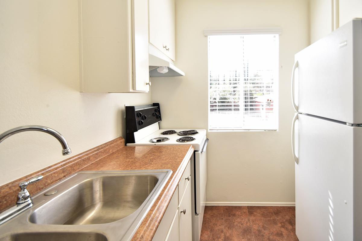 a kitchen with a stove sink and refrigerator