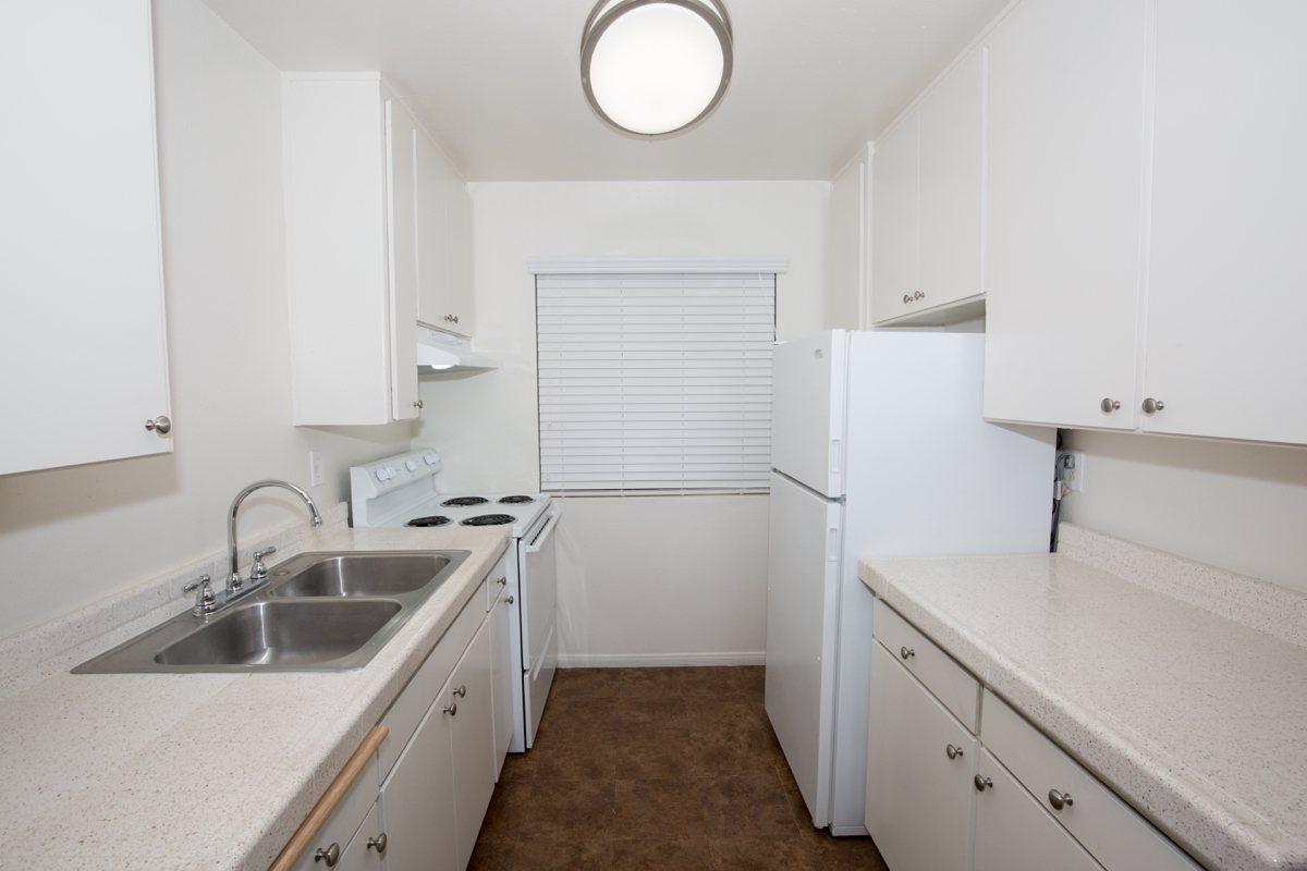 a kitchen with a sink and a refrigerator