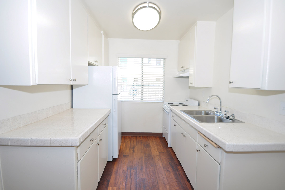 a kitchen with white cabinets and a sink