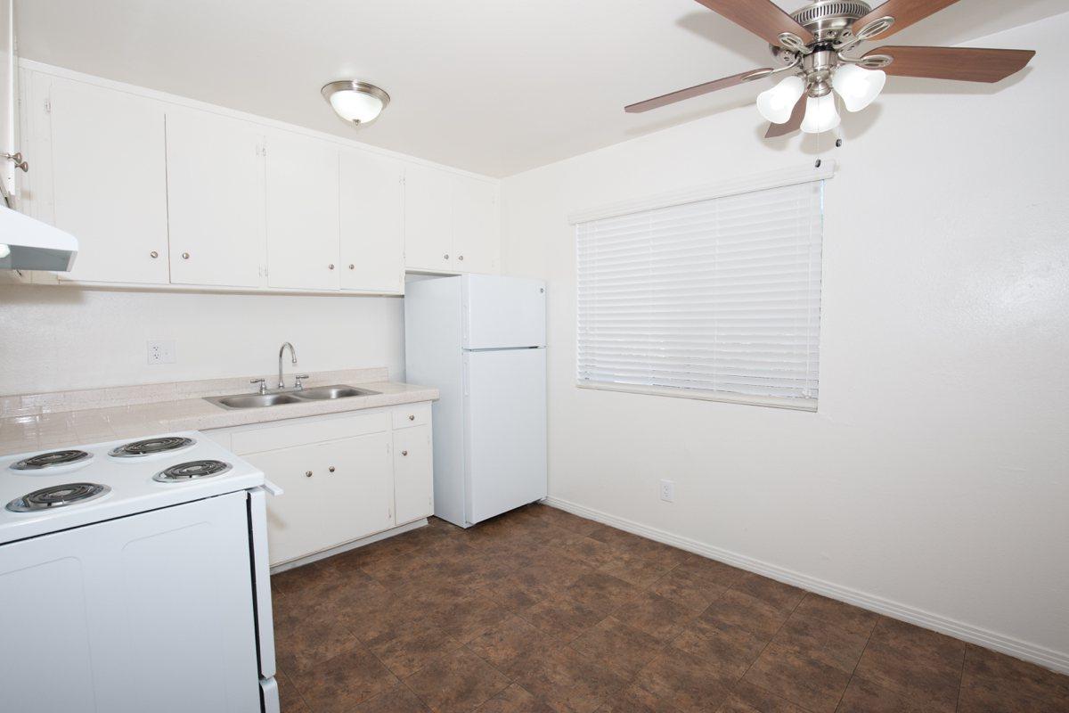 a white refrigerator freezer sitting inside of a kitchen