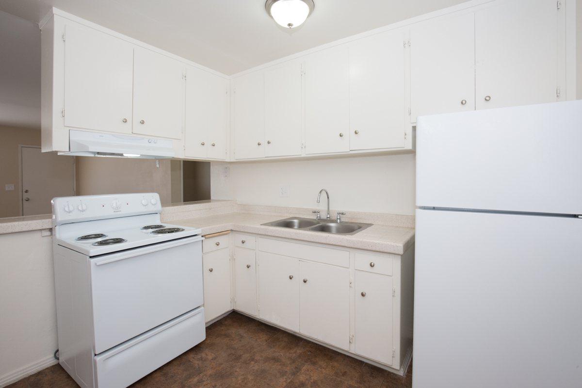 a white refrigerator freezer sitting inside of a kitchen