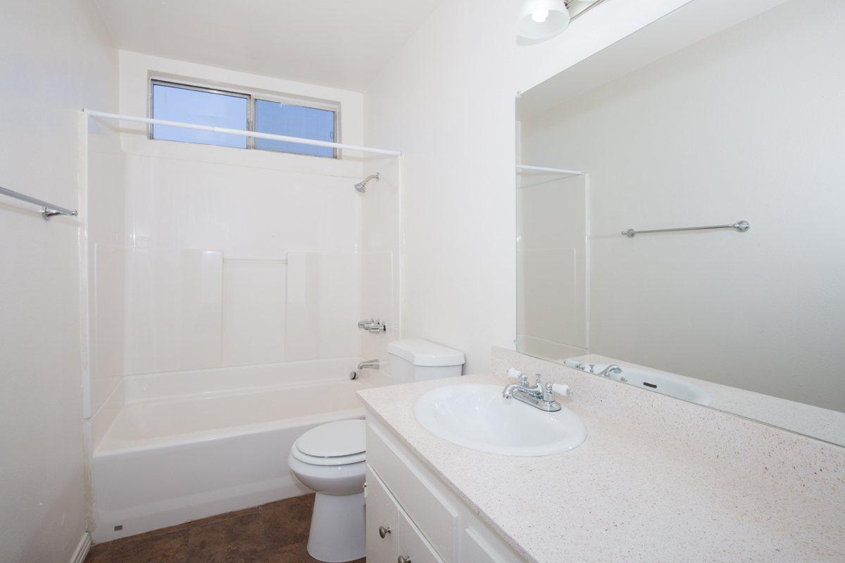 a large white tub next to a sink