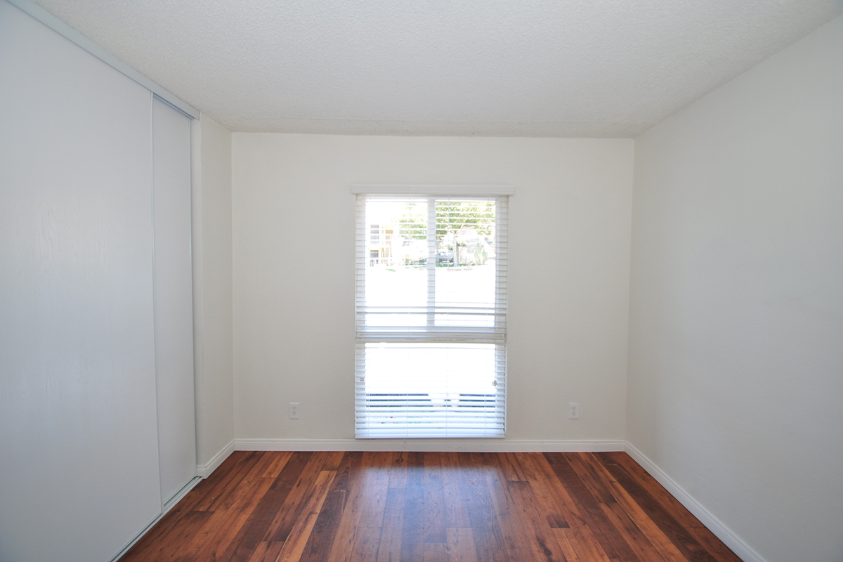 a close up of a hard wood floor next to a window