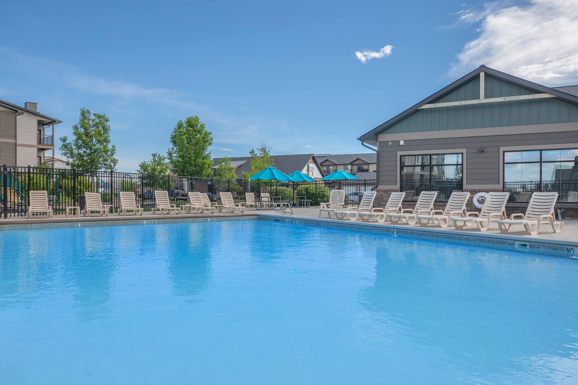 a large pool of water in front of a house