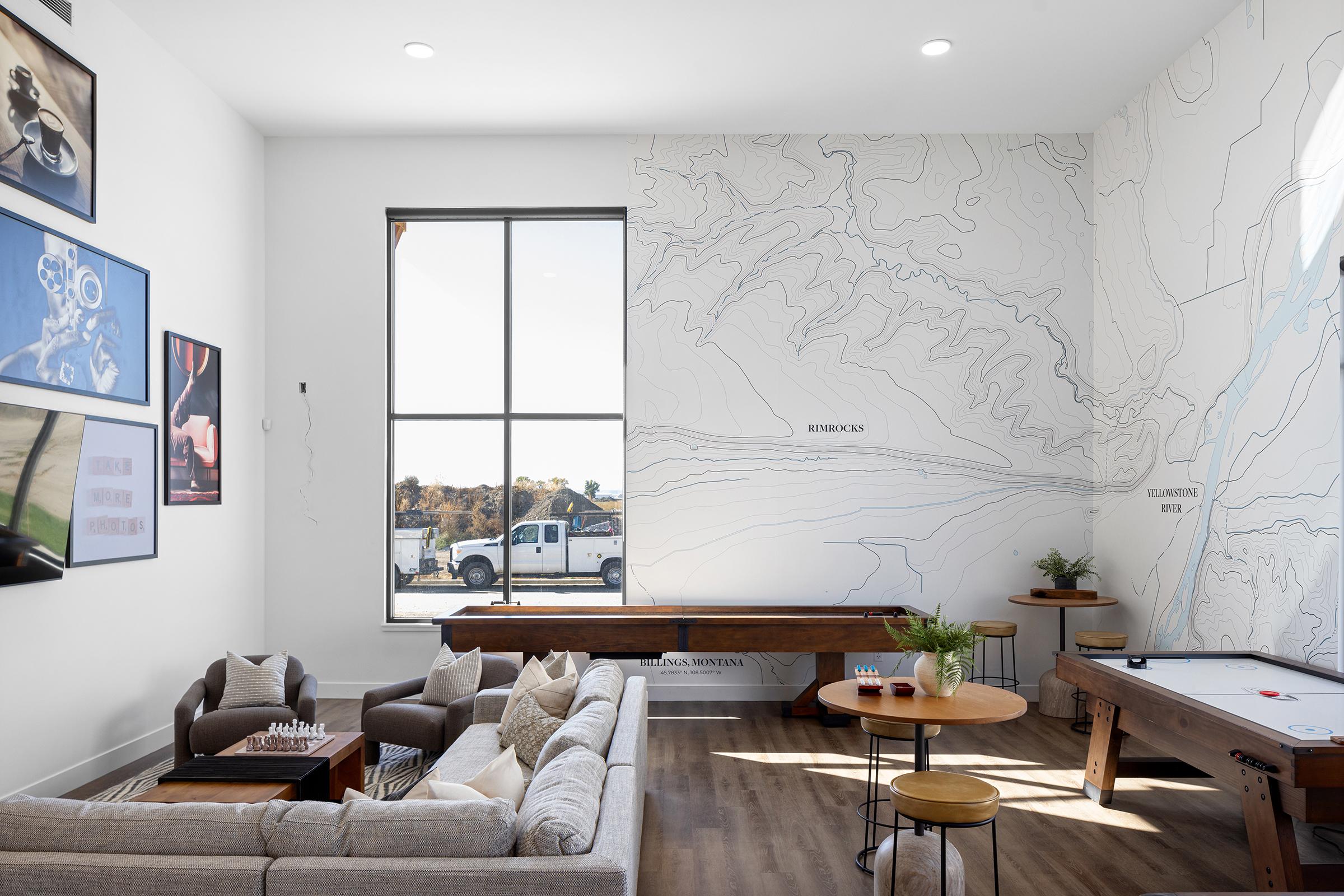 a living room filled with furniture and a large window