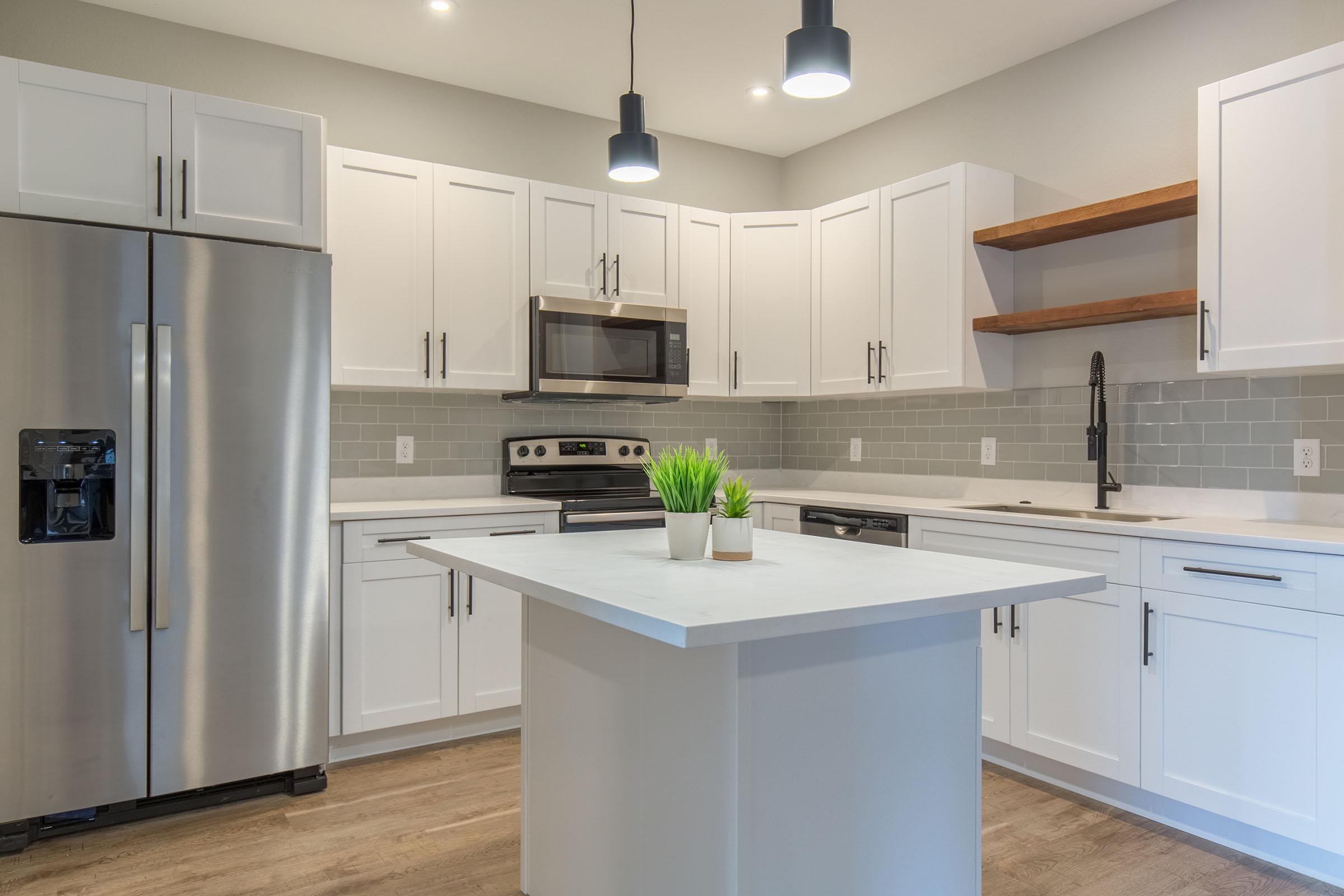 a large kitchen with stainless steel appliances