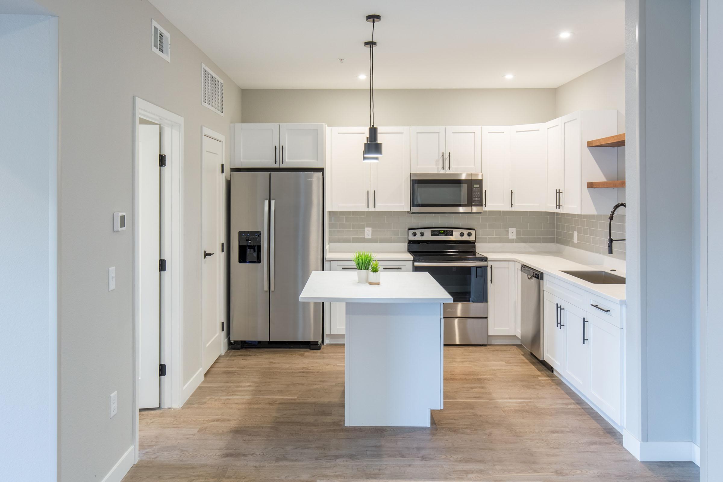 a kitchen with a sink and a refrigerator