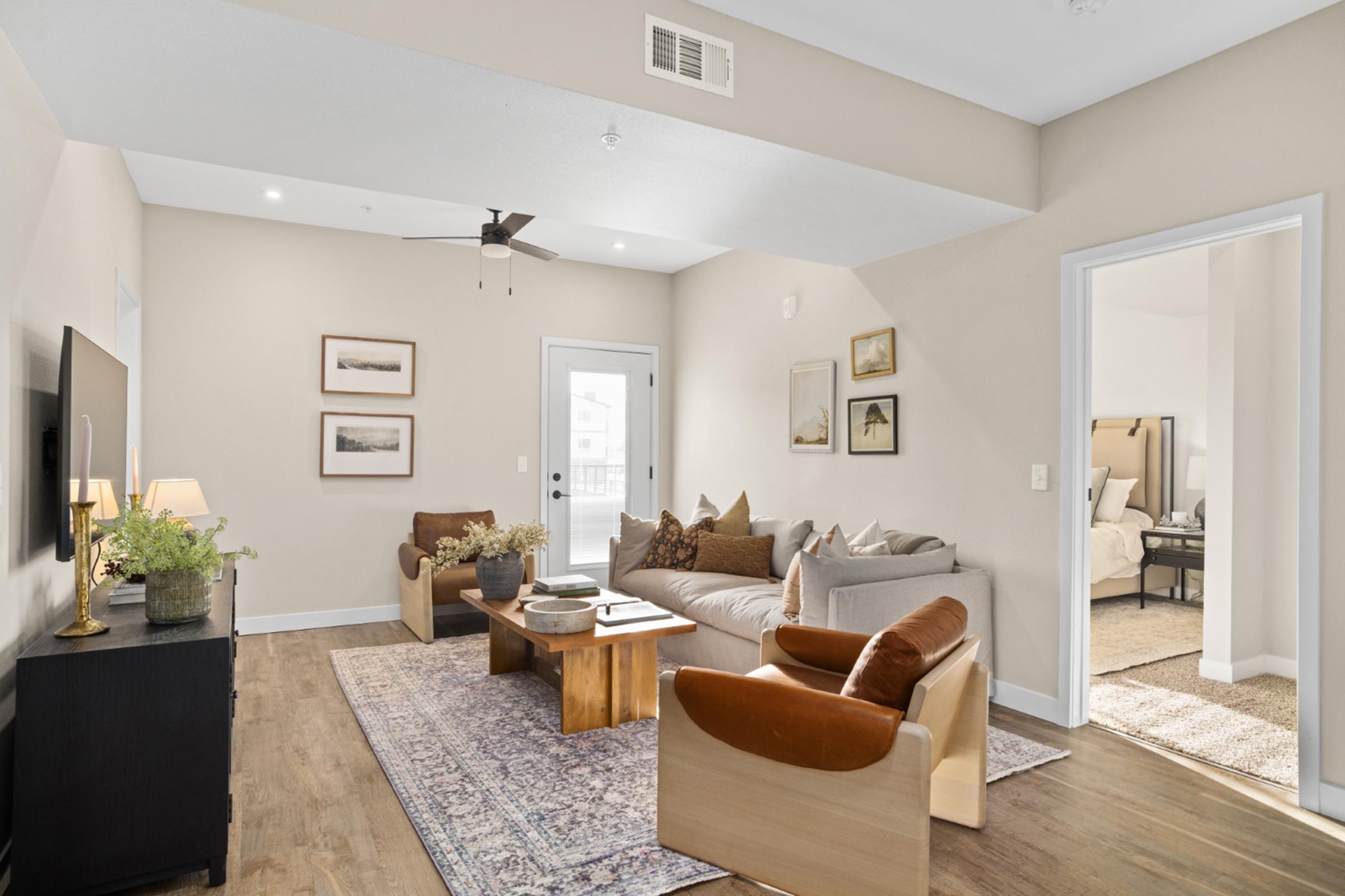 a living room filled with furniture and a large window