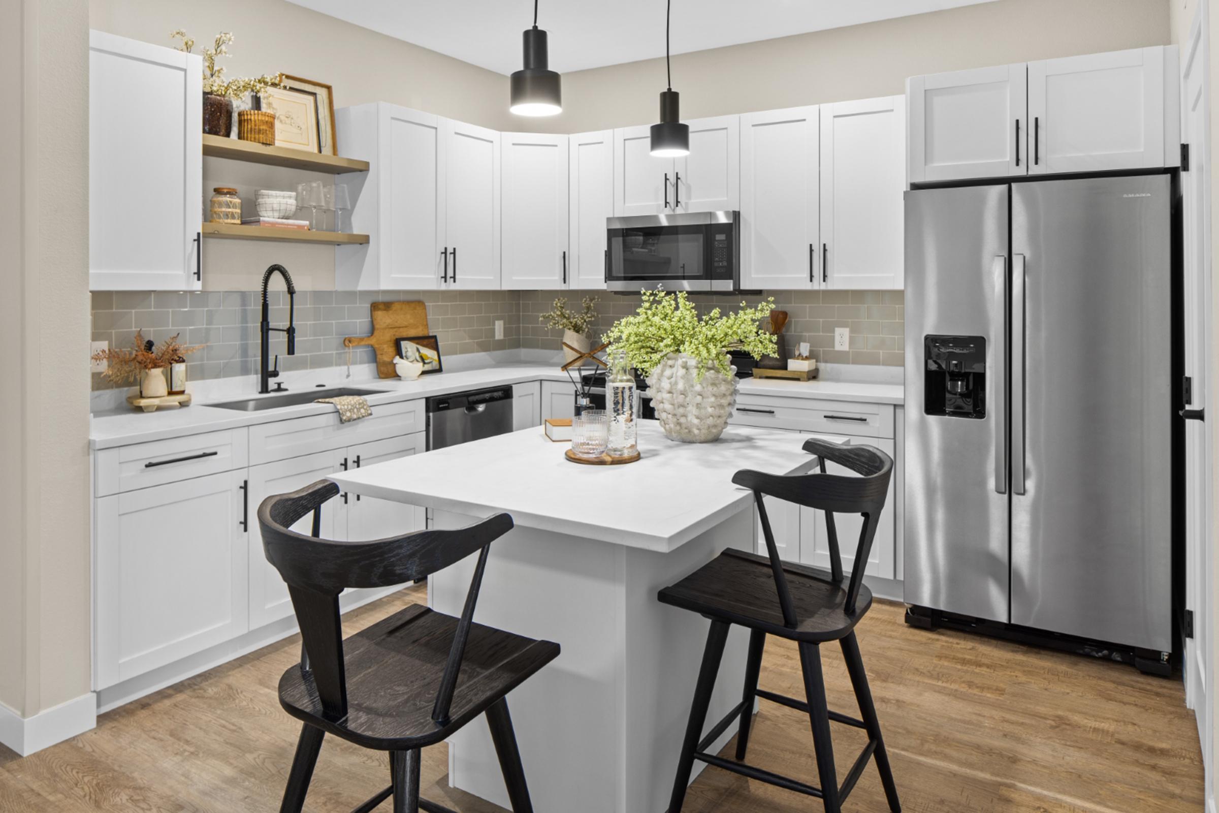 a kitchen with an island in the middle of a room