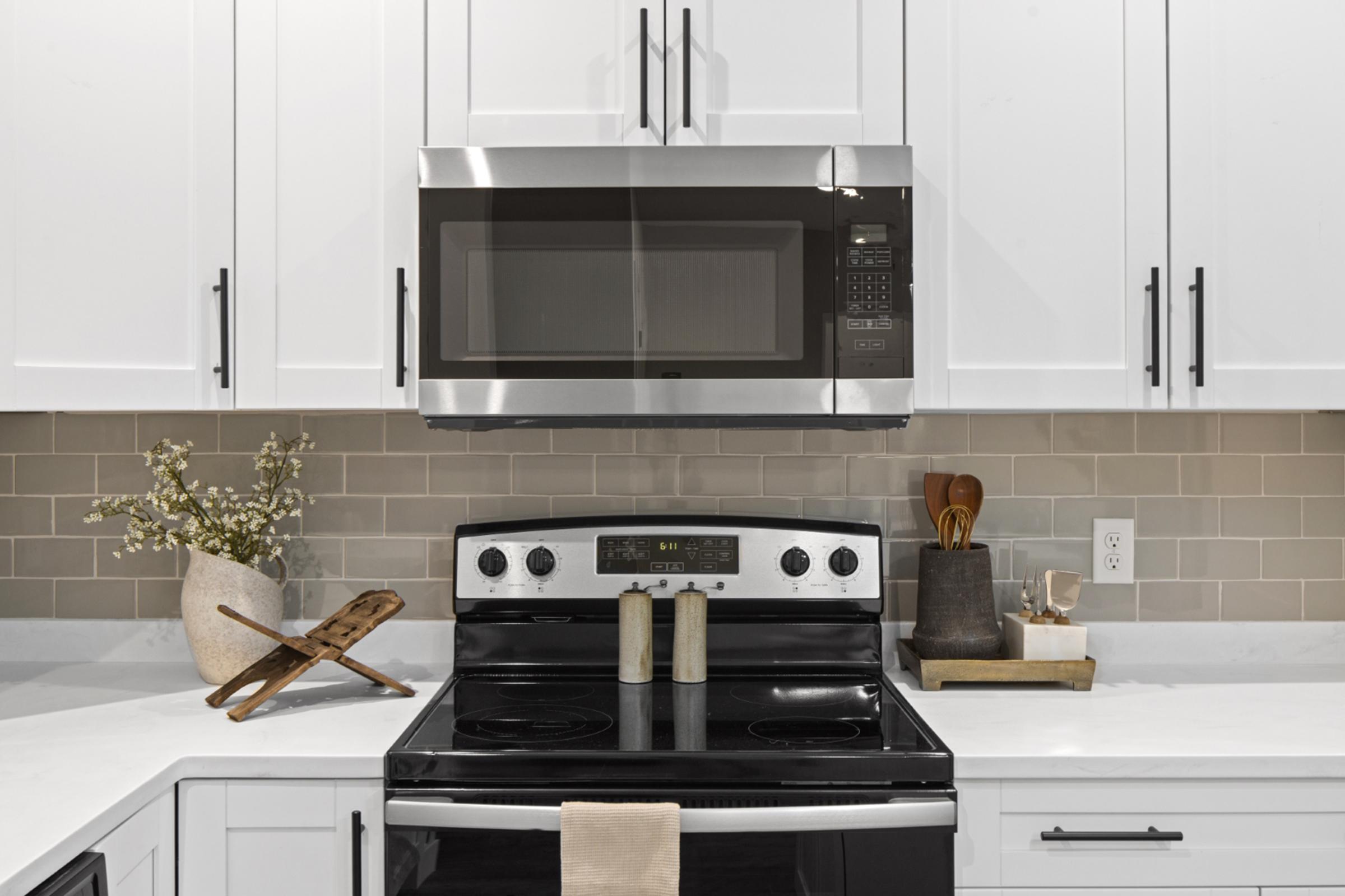 a kitchen with a stove top oven sitting inside of a microwave