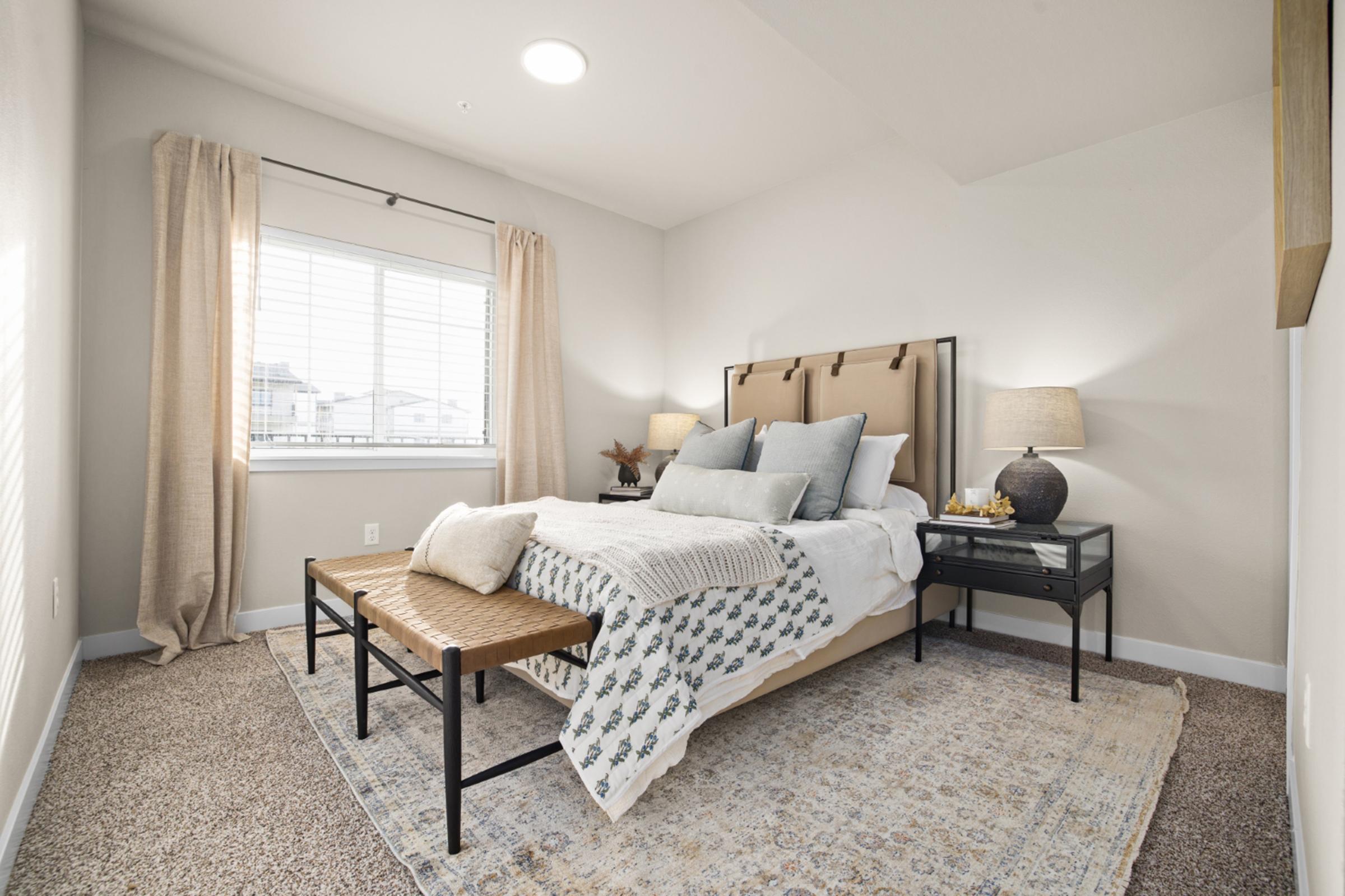 a bedroom with a bed and desk in a room