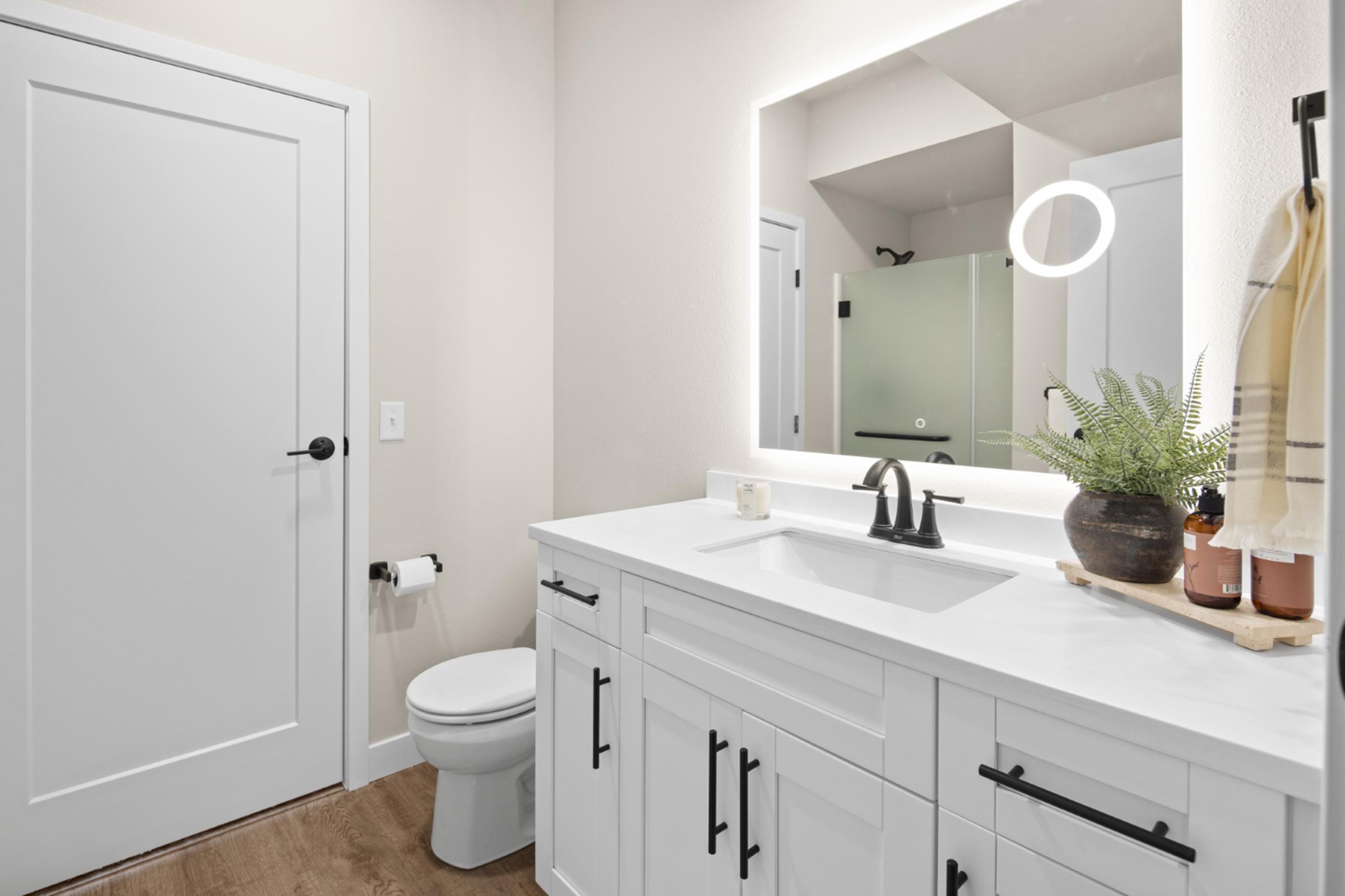 a kitchen with a sink and a mirror