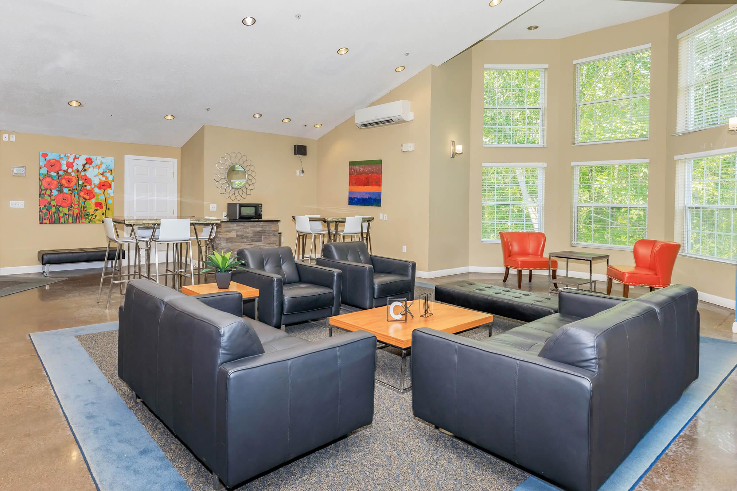 a living room filled with furniture and a large window