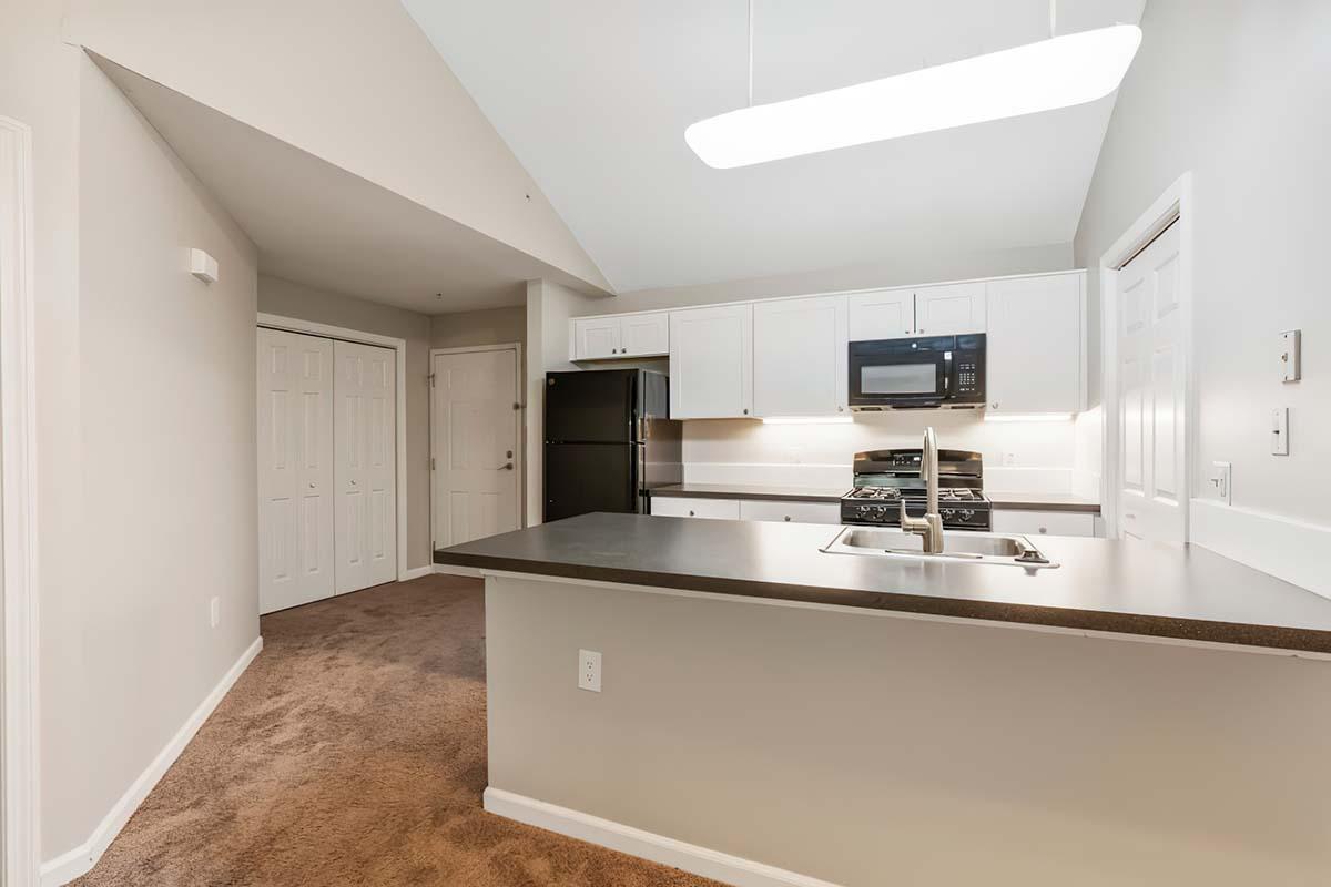 a kitchen with a sink and a mirror