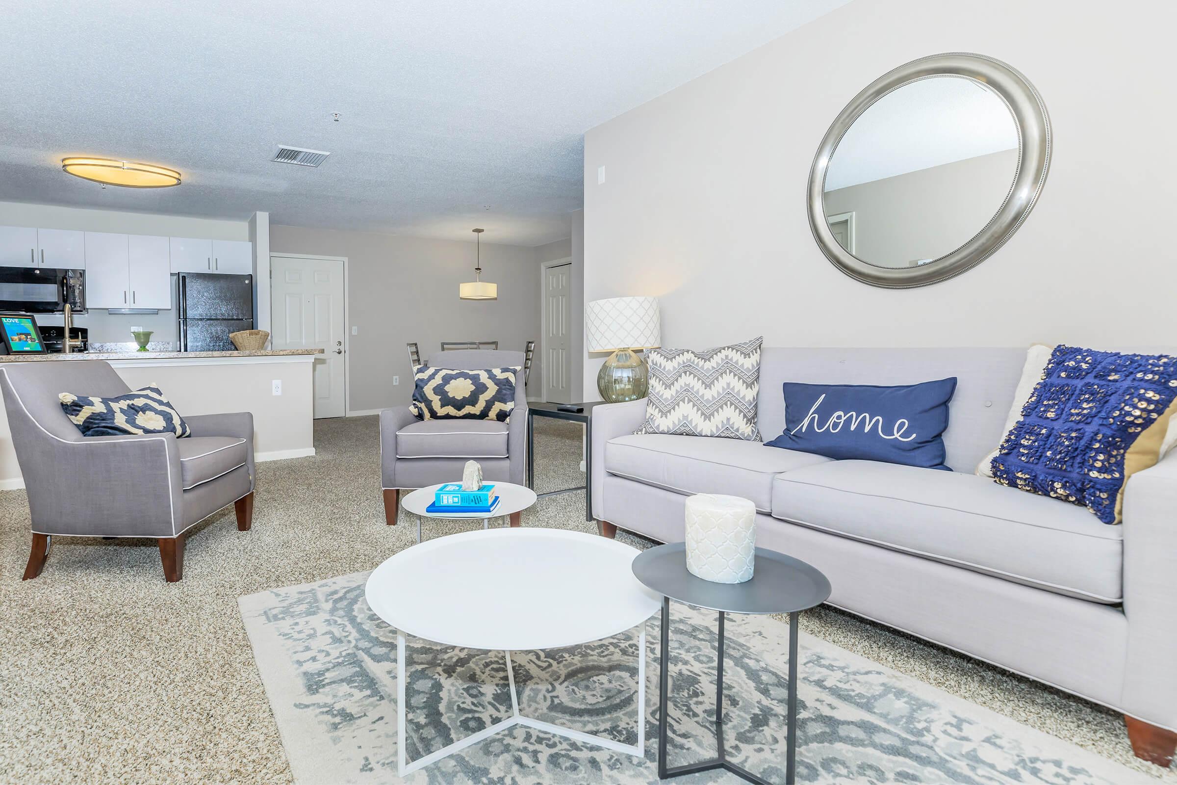 a living room filled with furniture and a bed