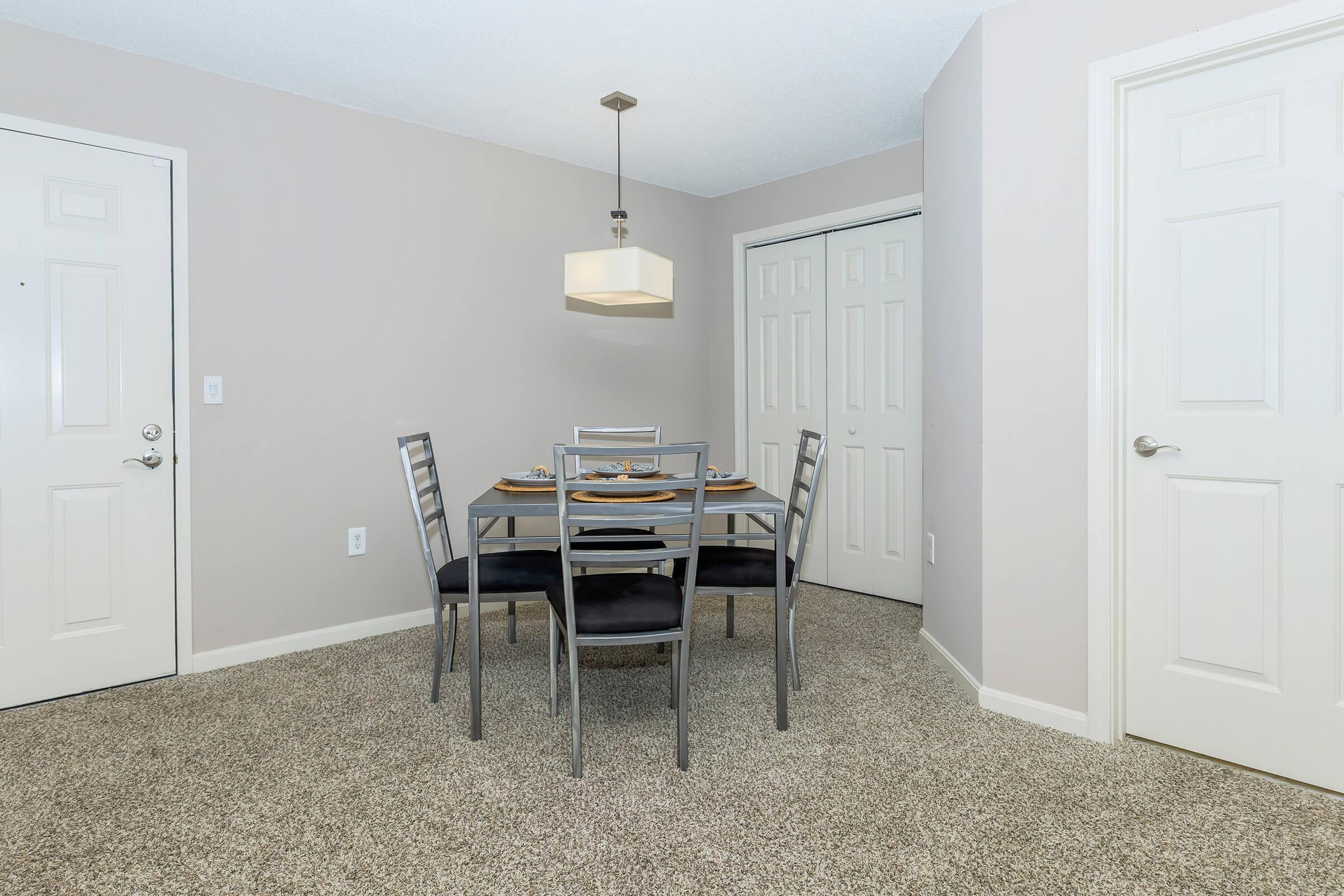 a bedroom with a desk and chair in a room