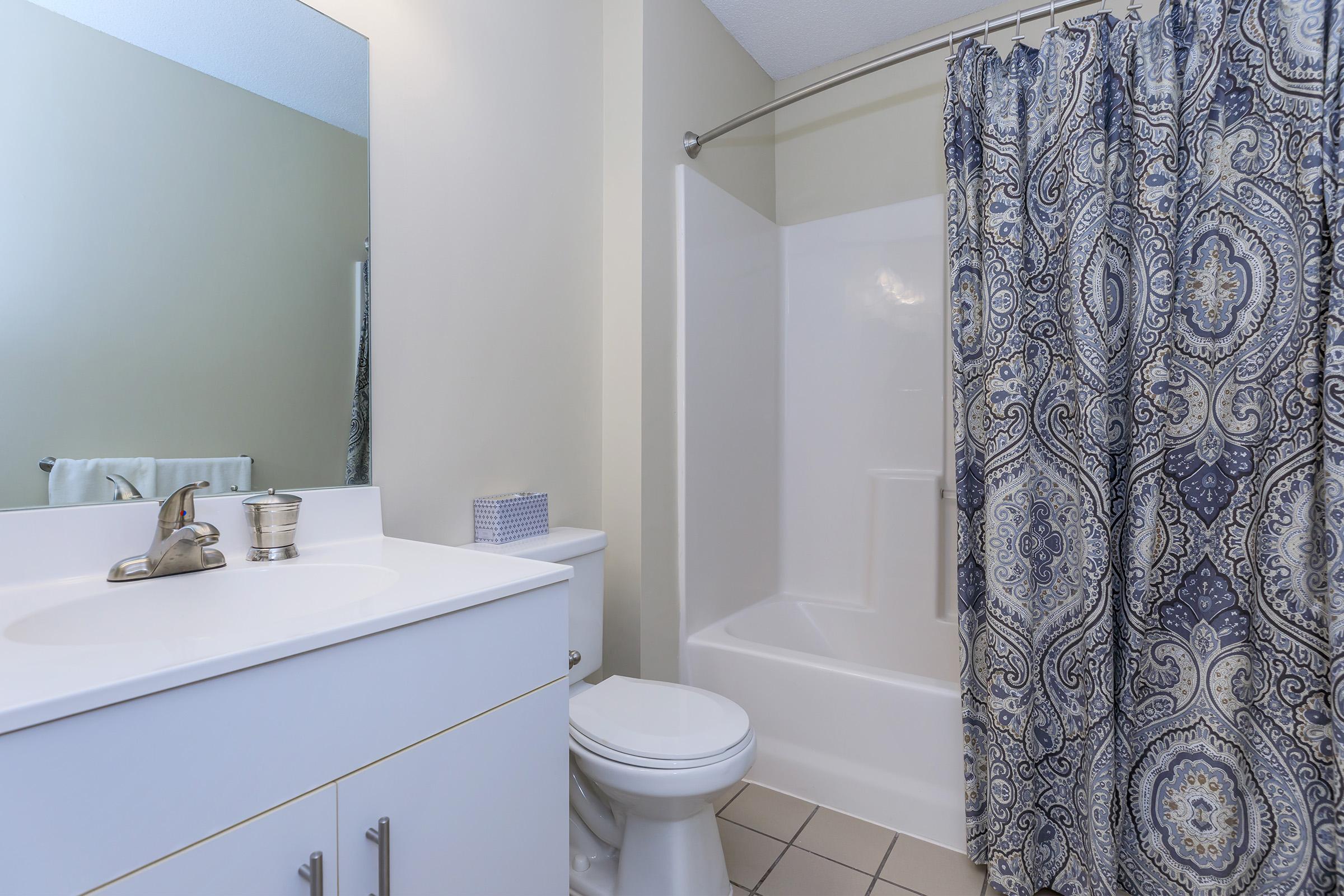 a shower curtain next to a sink