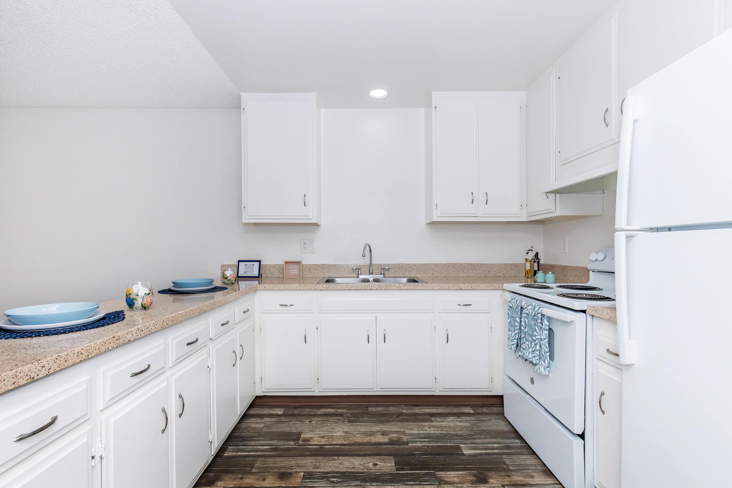 a kitchen with a stove and a refrigerator