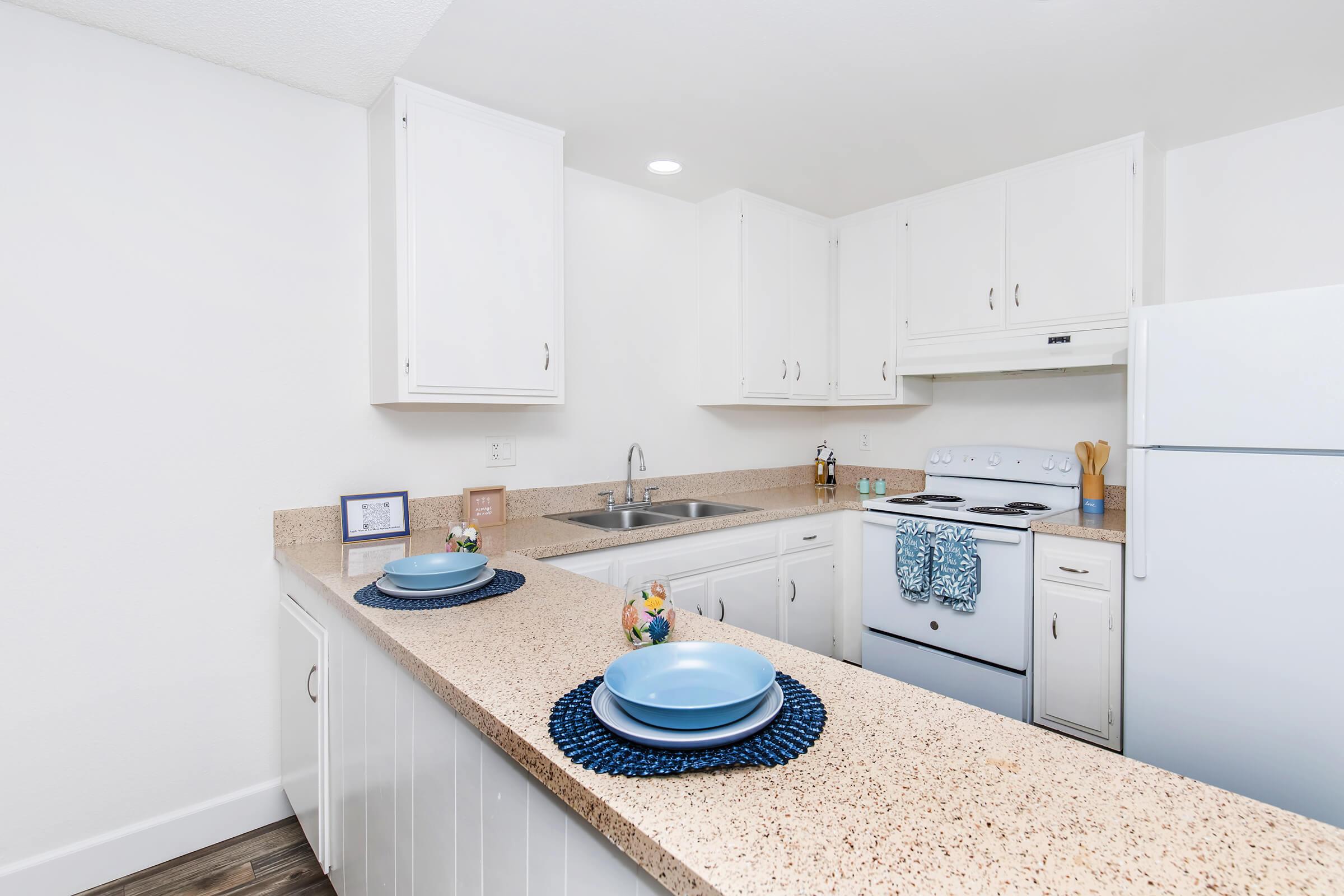 a kitchen with a sink and a refrigerator