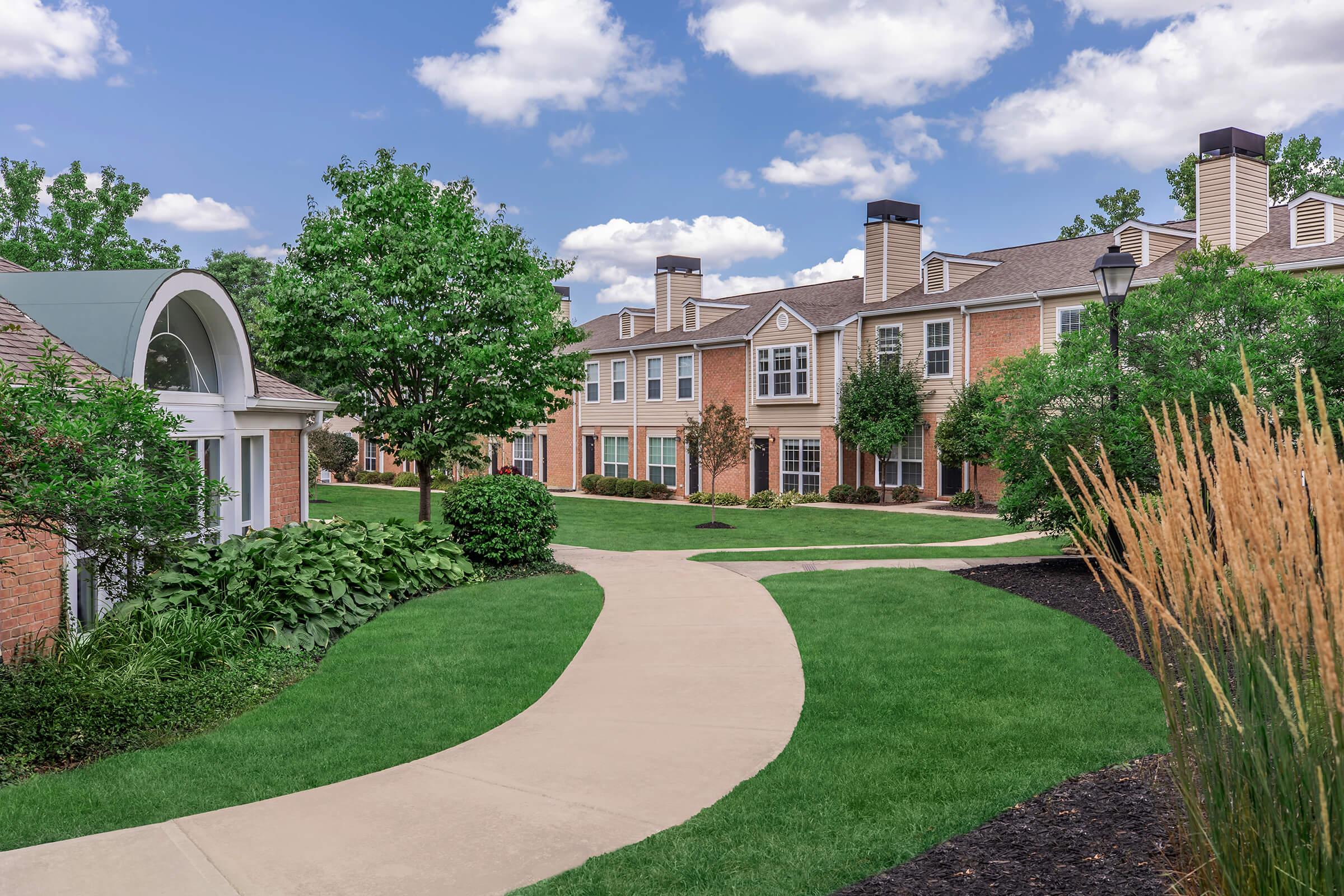 a large lawn in front of a brick building