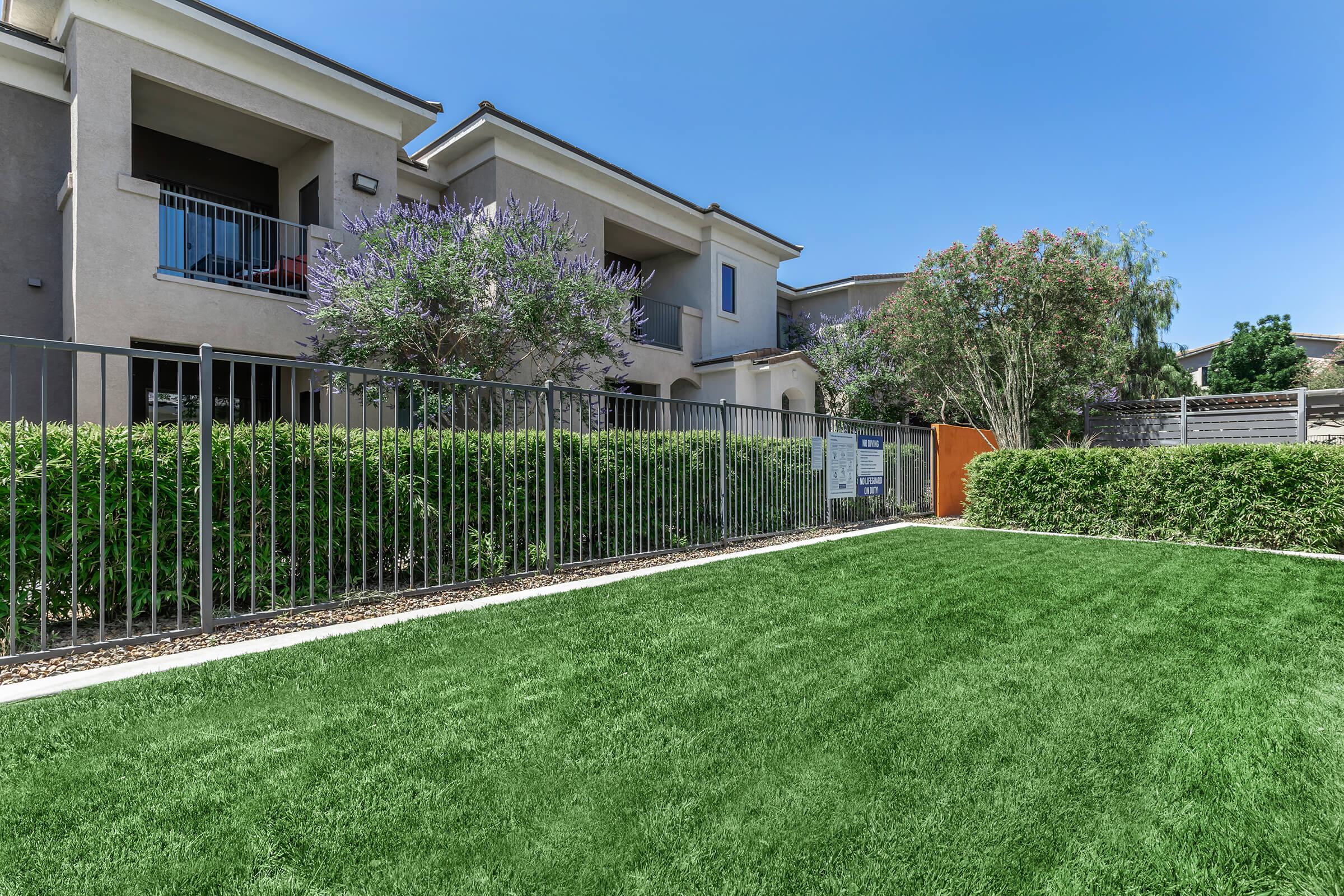 a green lawn in front of a house