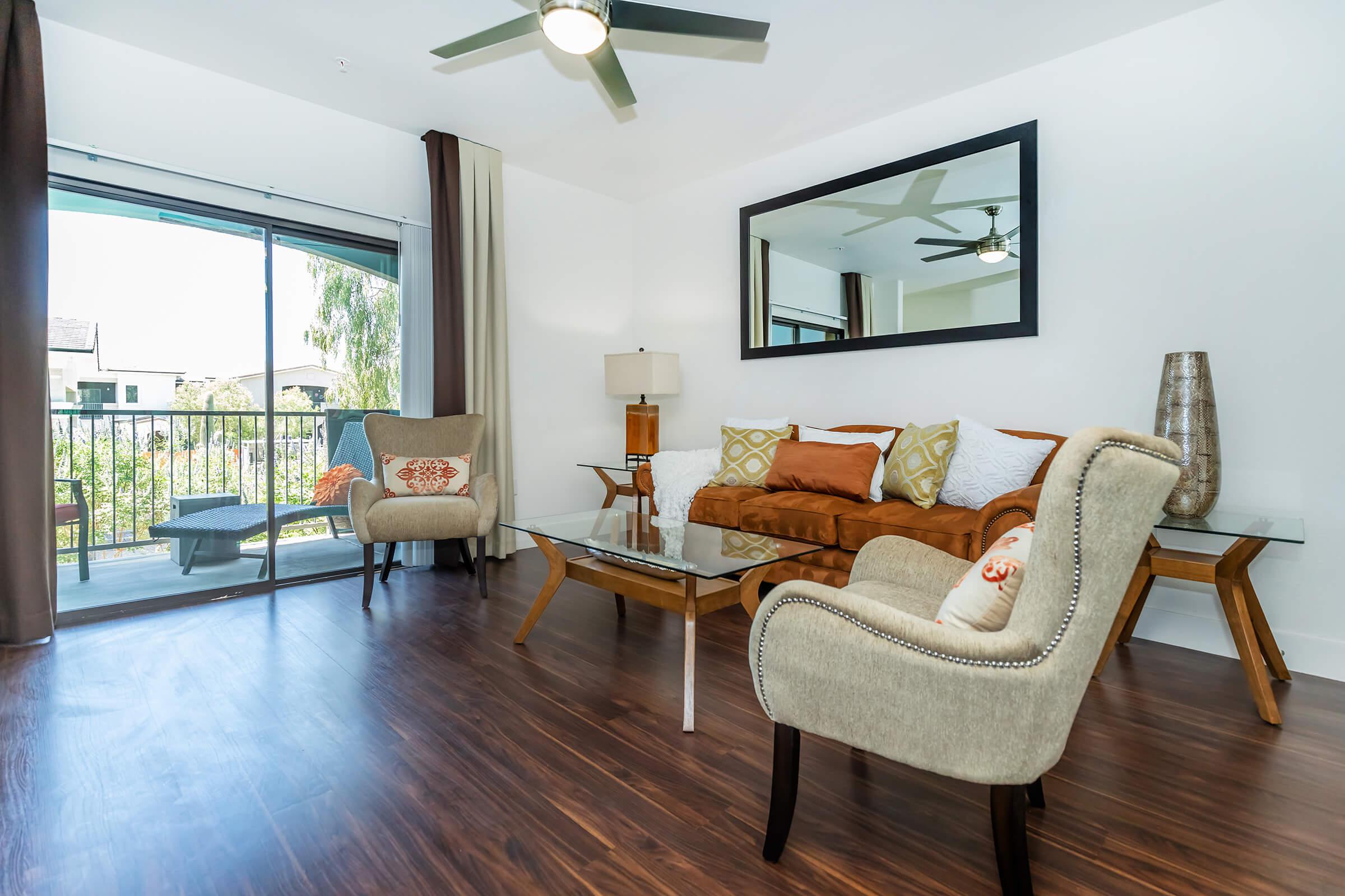 a living room filled with furniture and a large window