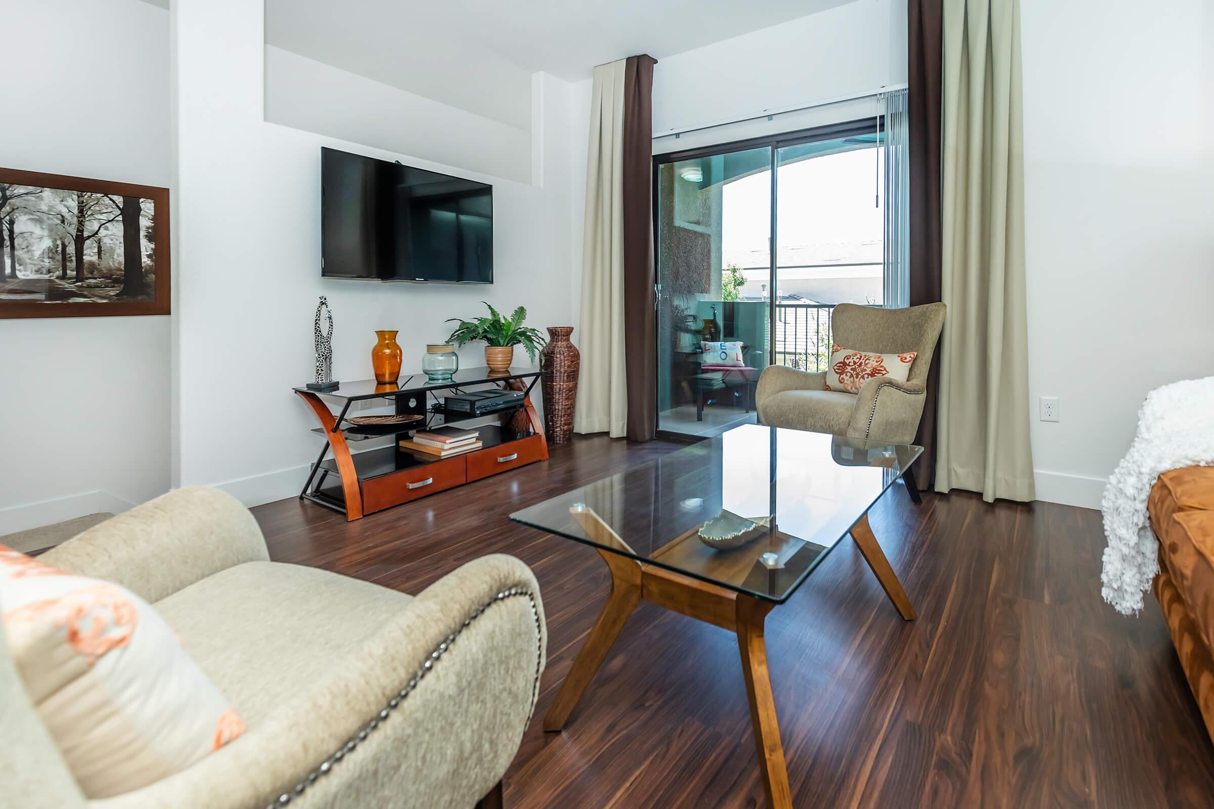 a living room filled with furniture and a large window