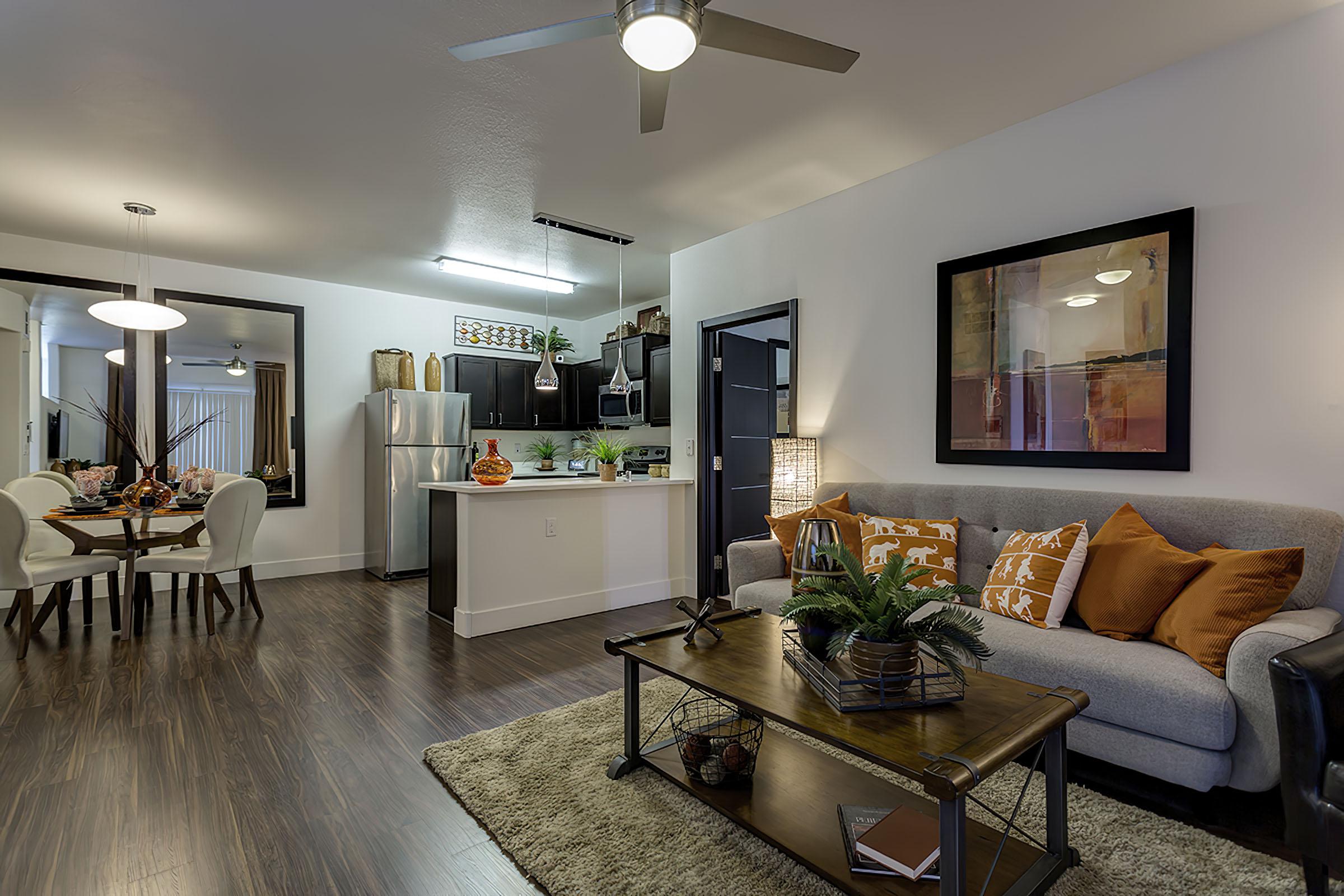 a living room filled with furniture and a large mirror