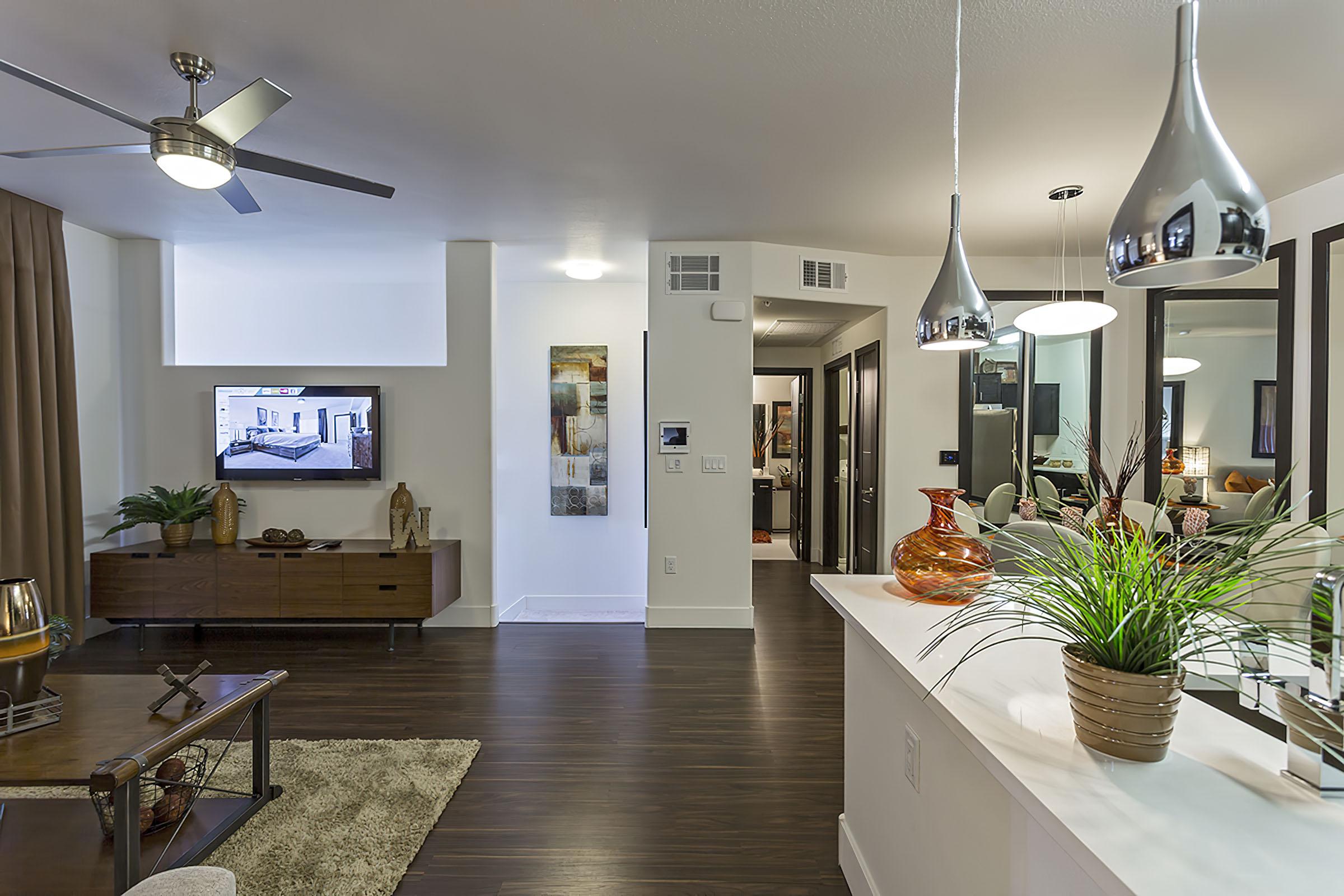 a living room filled with furniture and vase of flowers on a table