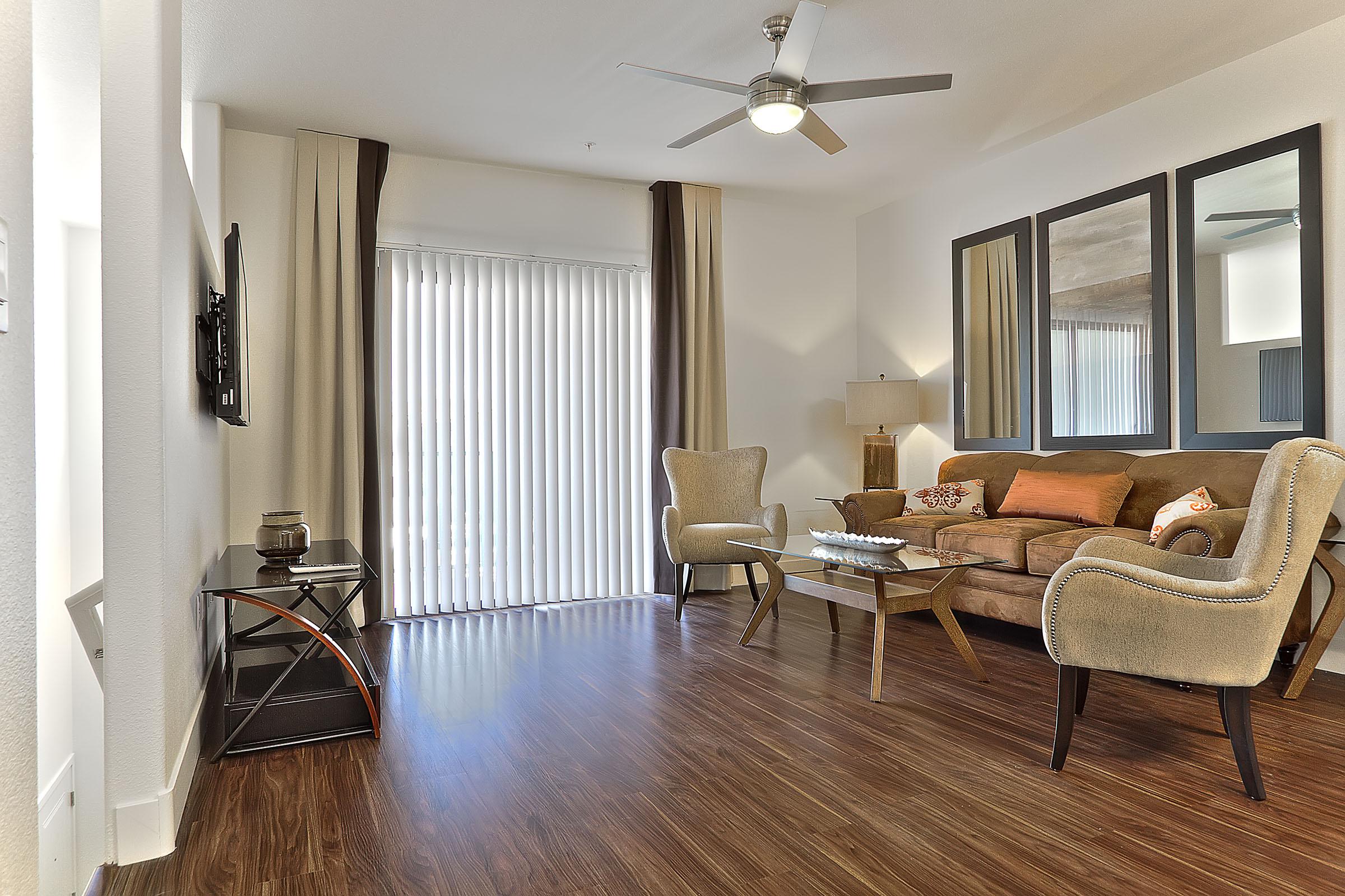 a living room filled with furniture and a large window