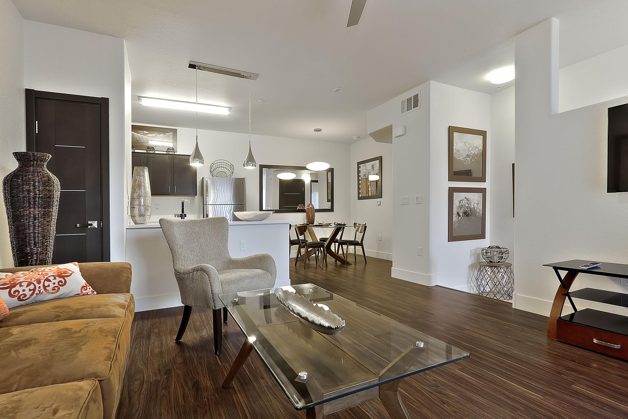 a living room filled with furniture and a large mirror