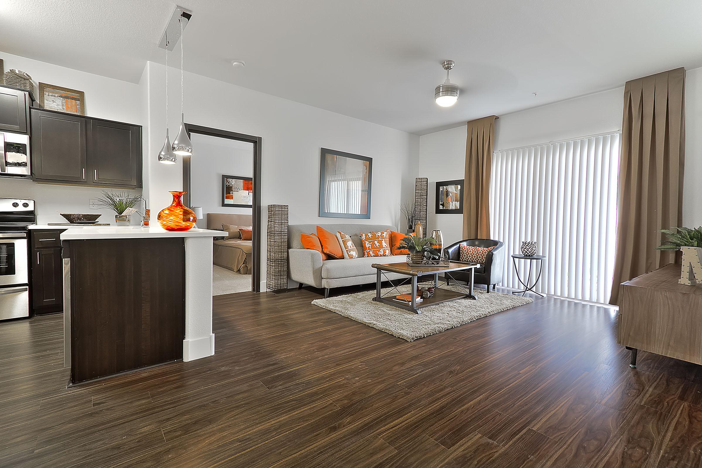 a living room filled with furniture and a large window