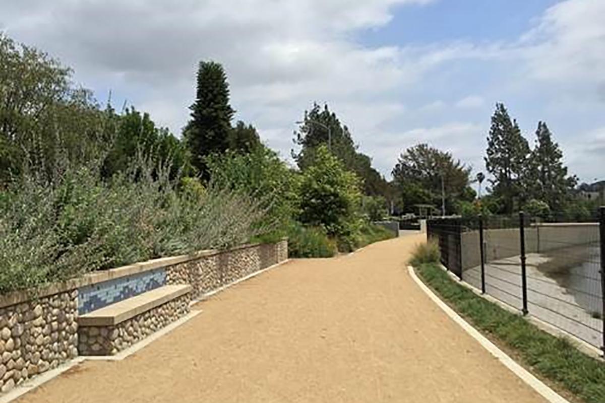 Outdoor walkway with a stone bench