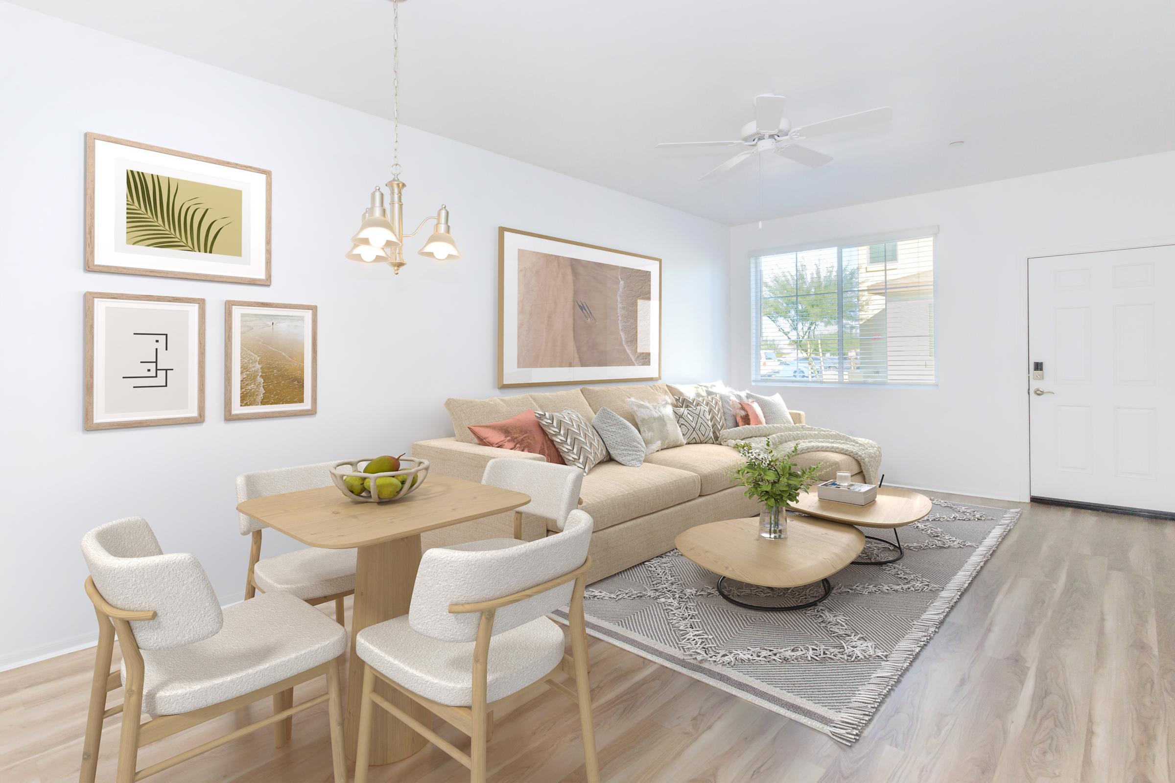 Bright and modern living space featuring a cozy sofa adorned with decorative pillows, a light wooden dining table with soft chairs, and stylish coffee tables. The walls are decorated with framed artwork, and there’s a window allowing natural light to enhance the warm ambiance.