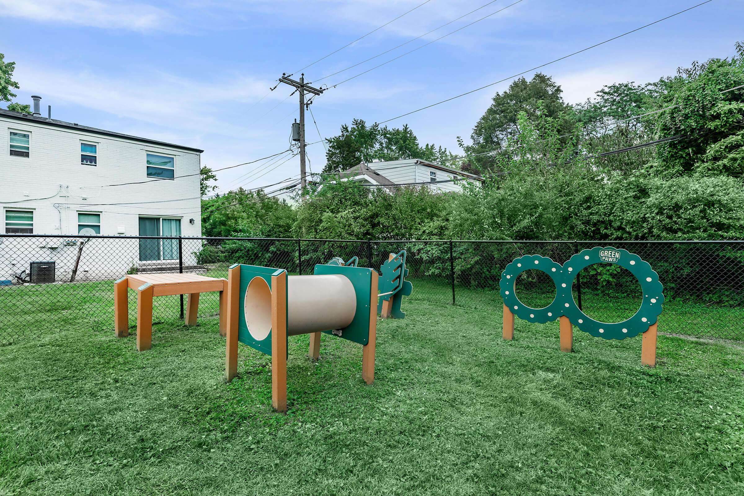 a group of lawn chairs sitting on top of a grass covered field