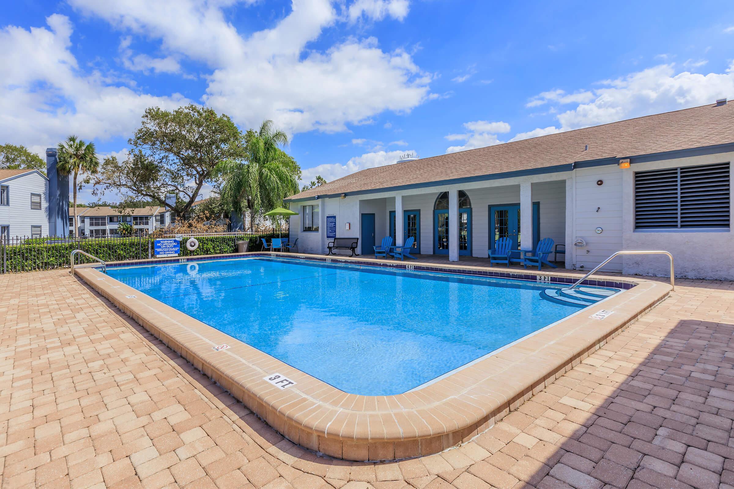 a pool next to a brick building