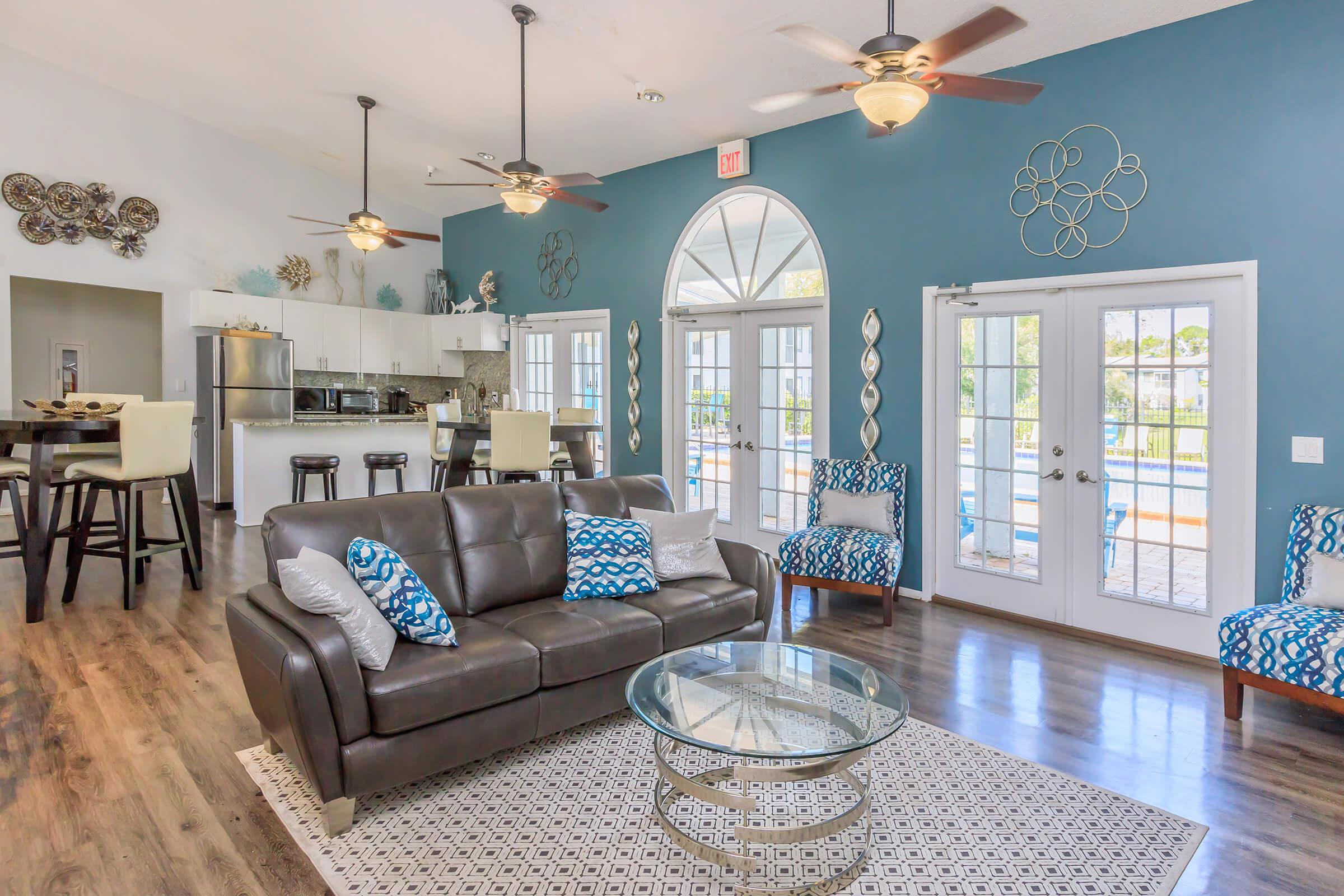 a view of a living room filled with furniture and a fire place