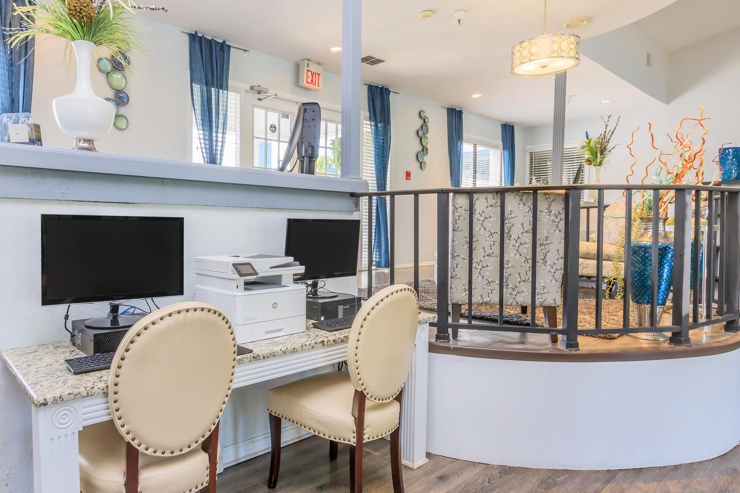 a room filled with furniture and vase of flowers on a table