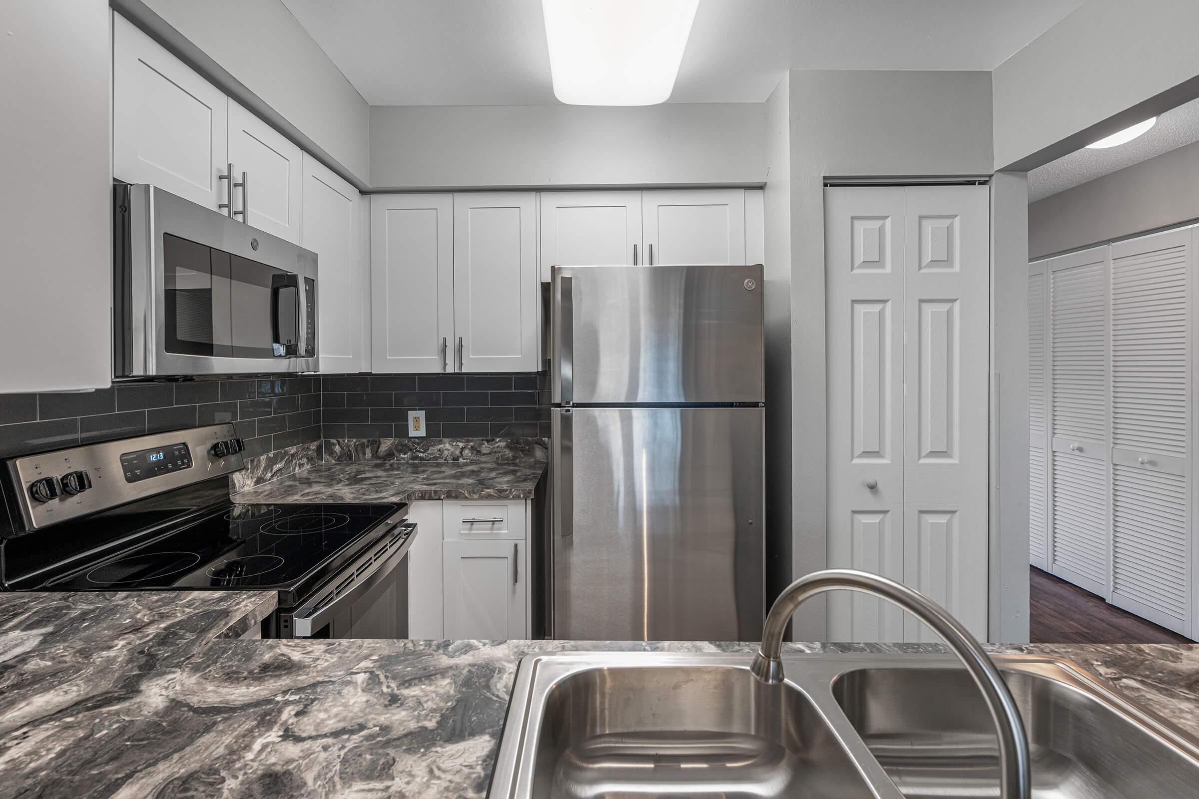 a modern kitchen with stainless steel appliances