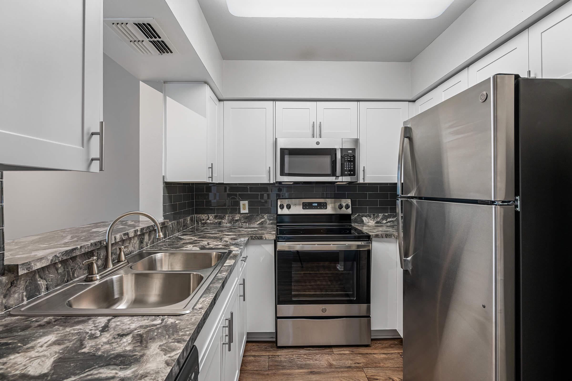 a large kitchen with stainless steel appliances