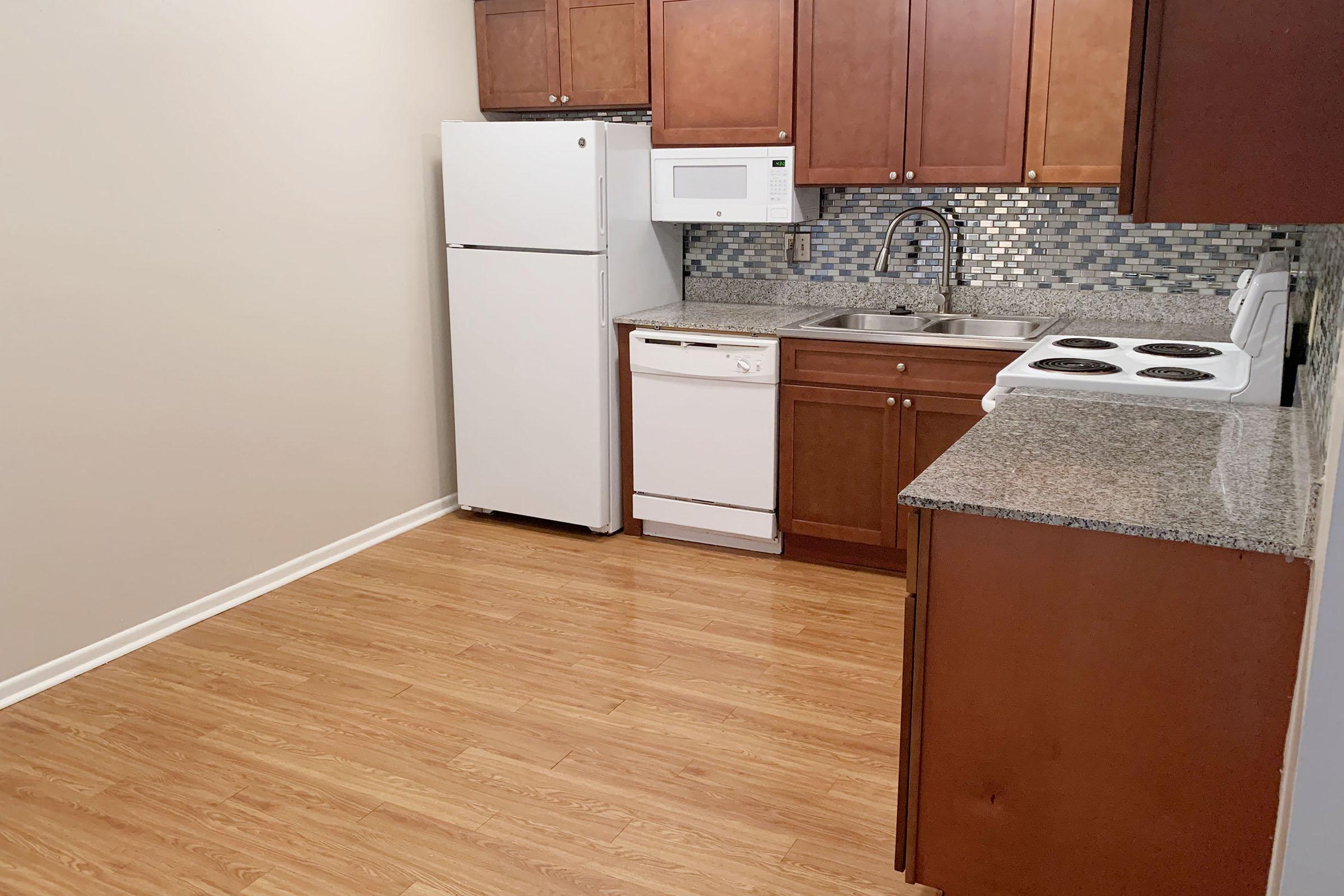 a kitchen with a stove and a refrigerator