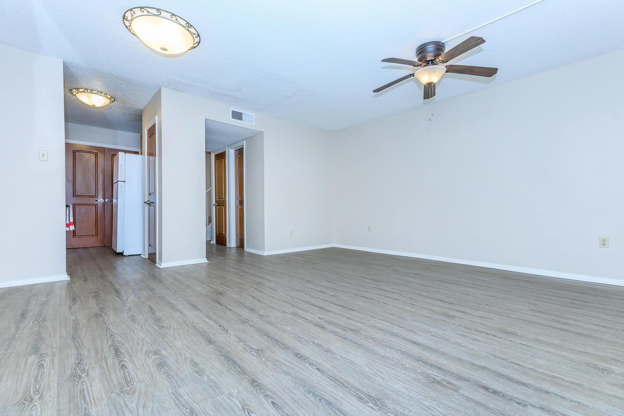 a bedroom with a wooden floor