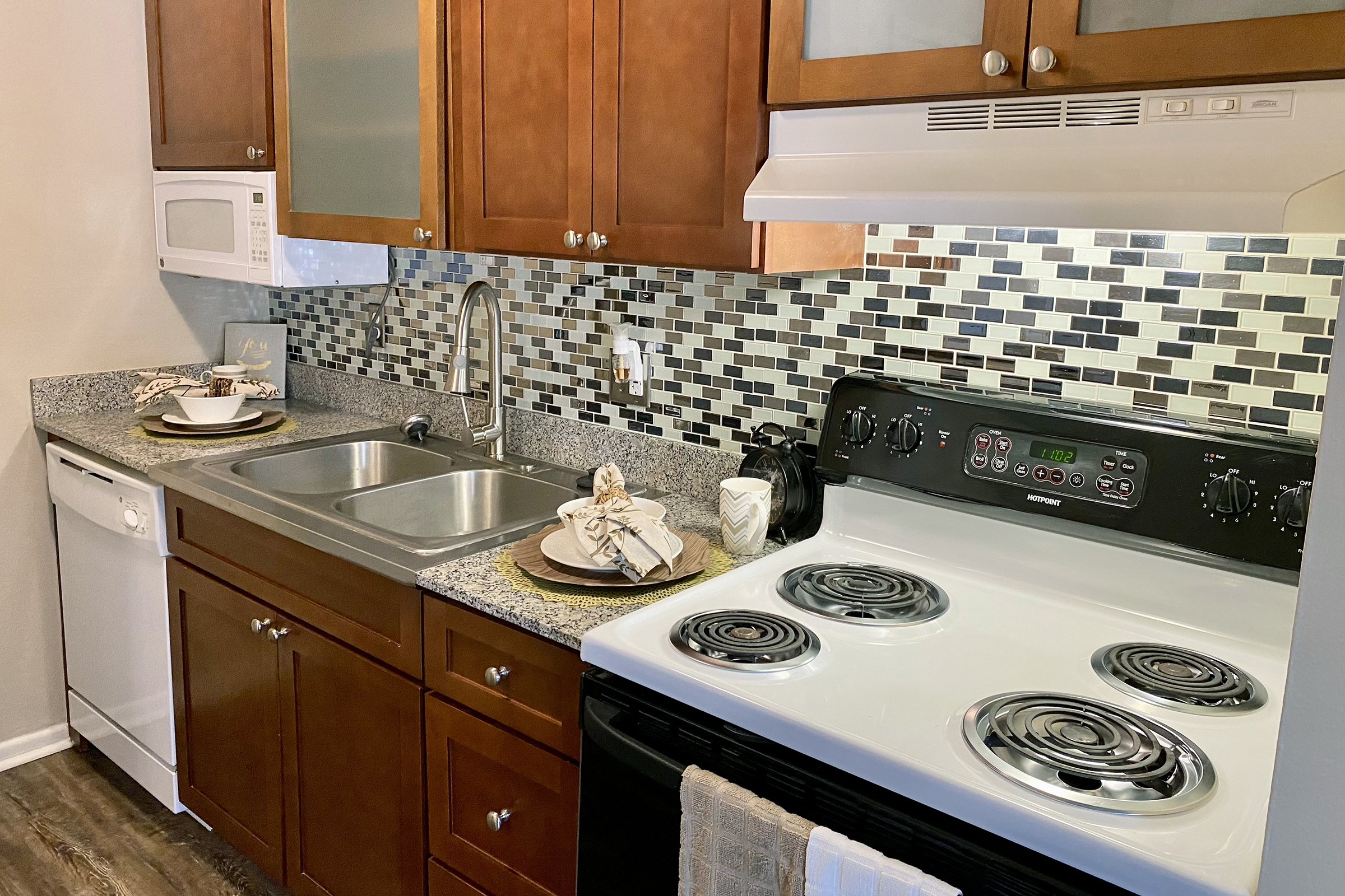 a stove top oven sitting inside of a kitchen